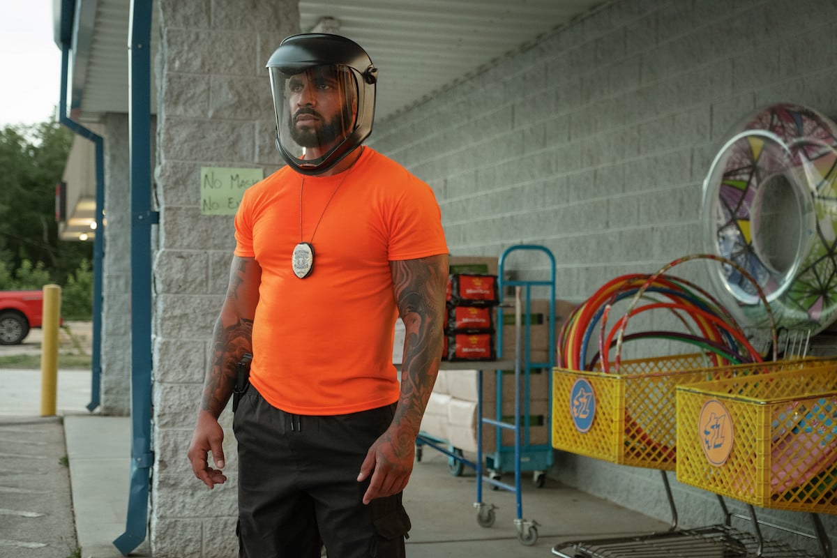 Tyler Lepley as Diamond wearing an orange shirt and a mask in 'P-Valley'