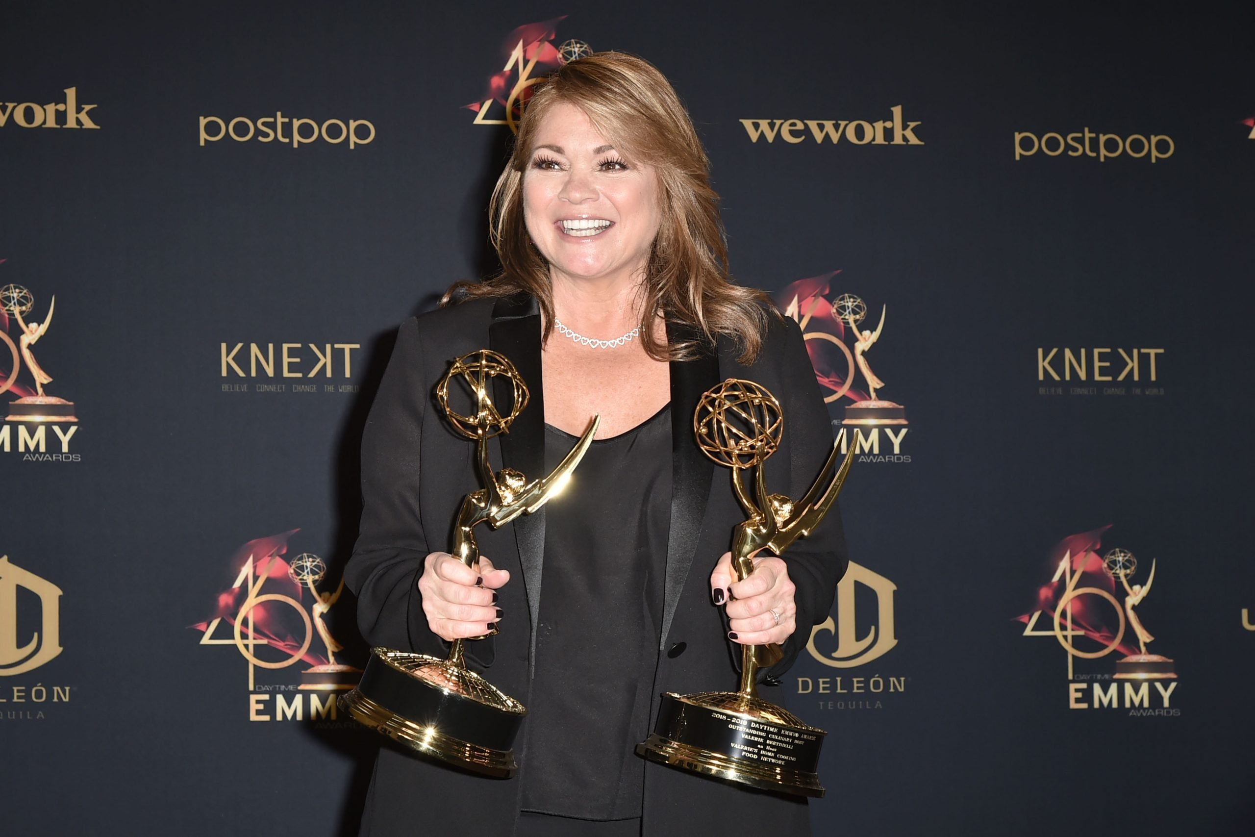 Food Network host Valerie Bertinelli shows off her two Daytime Emmy awards in 2019.