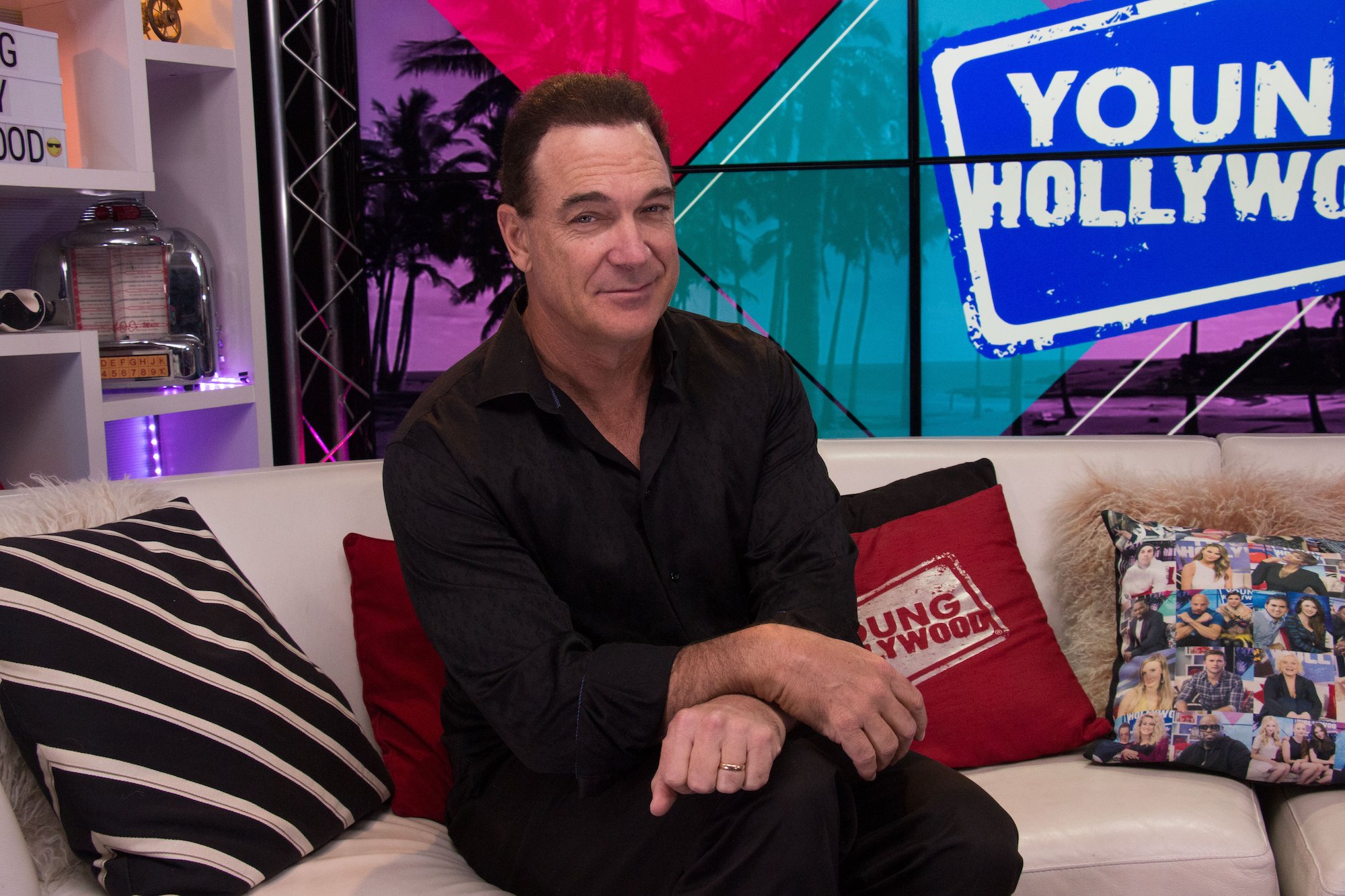 Actor Patrick Warburton wearing a black shirt and pants.