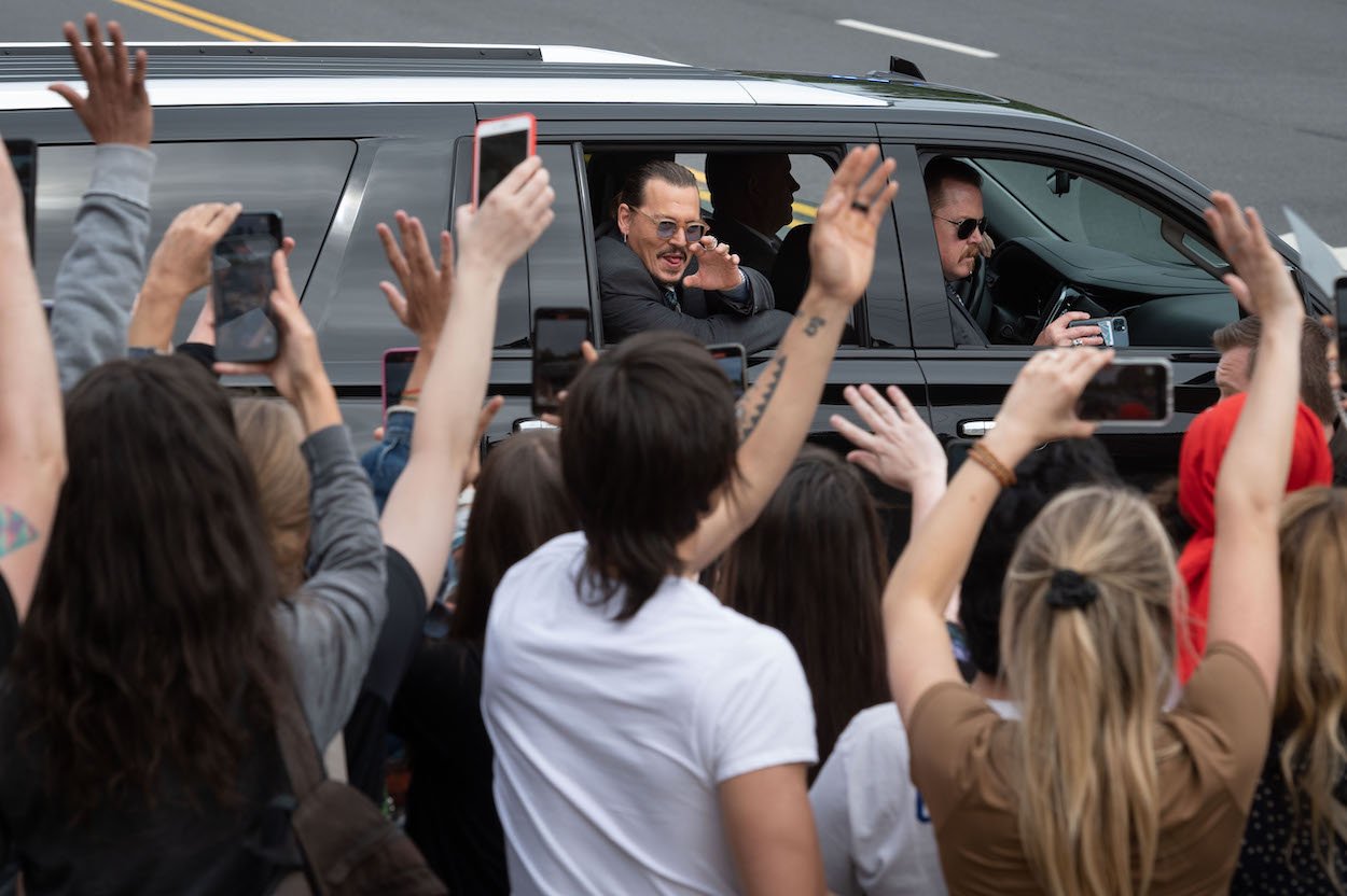 Johnny Depp waves to supporters as he leaves court during his defamation trial against ex-wife Amber Heard in Fairfax, Virginia. Heard implied Depp abused her in an op-ed, but many women support Depp despite Heard's claims.
