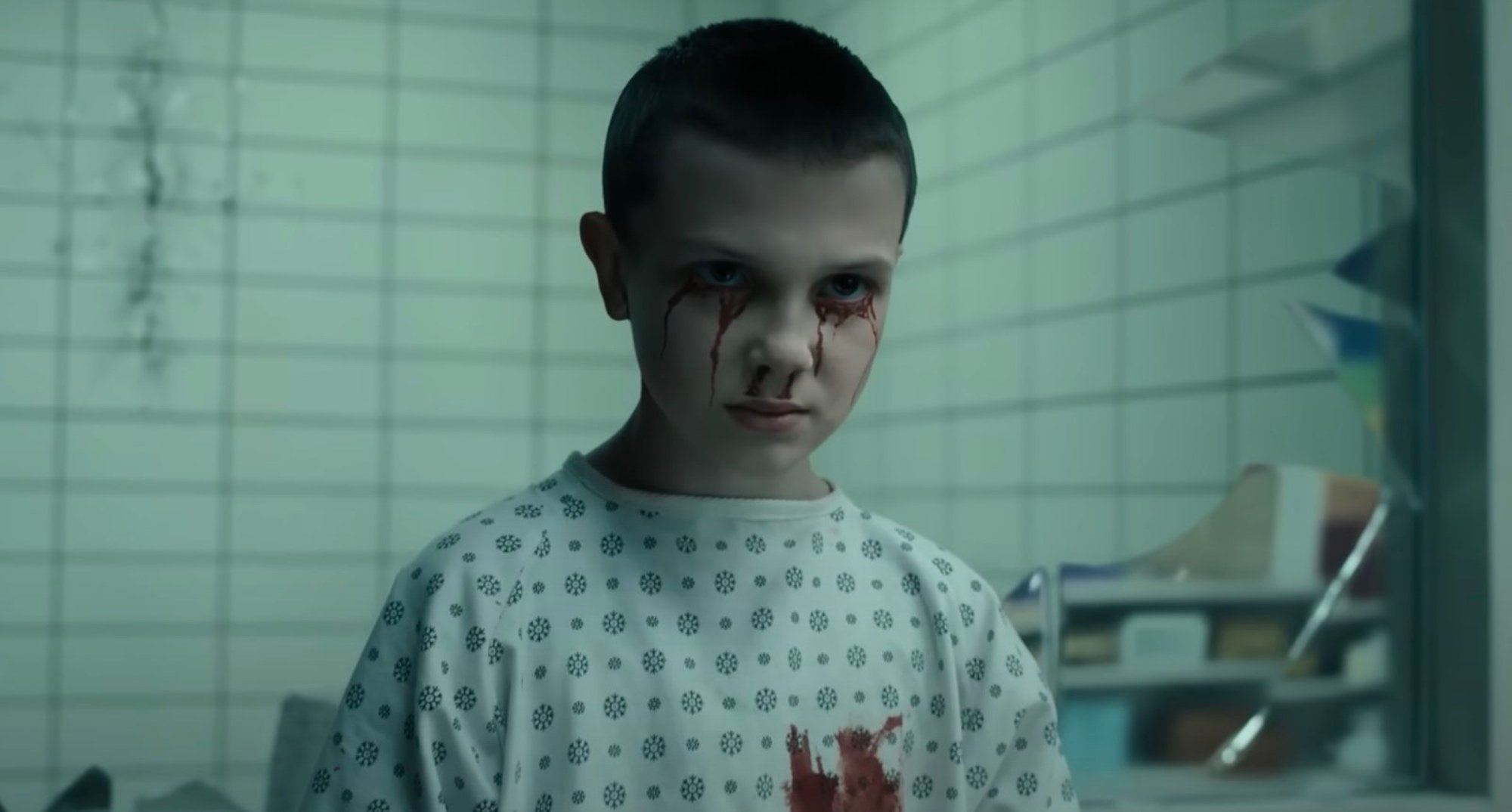 Young Eleven in 'Stranger Things' Season 4 in relation to her speech wearing hospital gown.