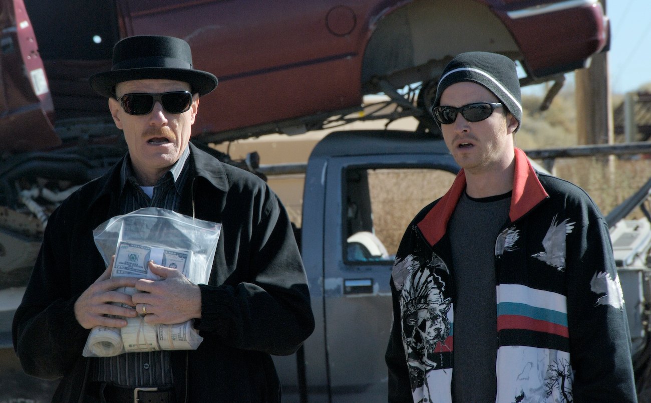 Walter White (Bryan Cranston) holds a bag of money standing next to Jesse Pinkman (Aaron Paul) in 'Breaking Bad' season 1