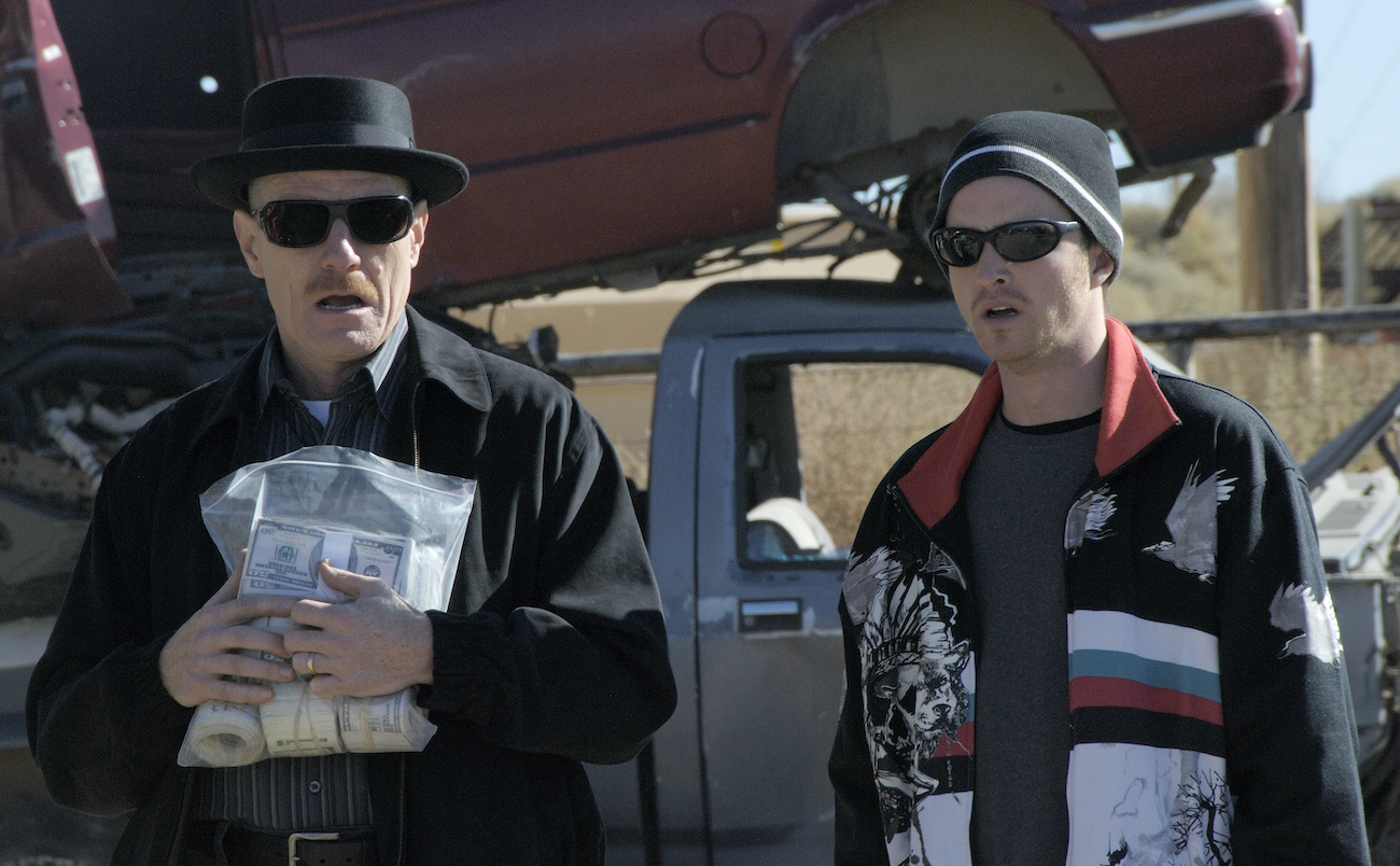 Walter White (Bryan Cranston) holds a bag of money standing next to Jesse Pinkman (Aaron Paul) in 'Breaking Bad' season 1