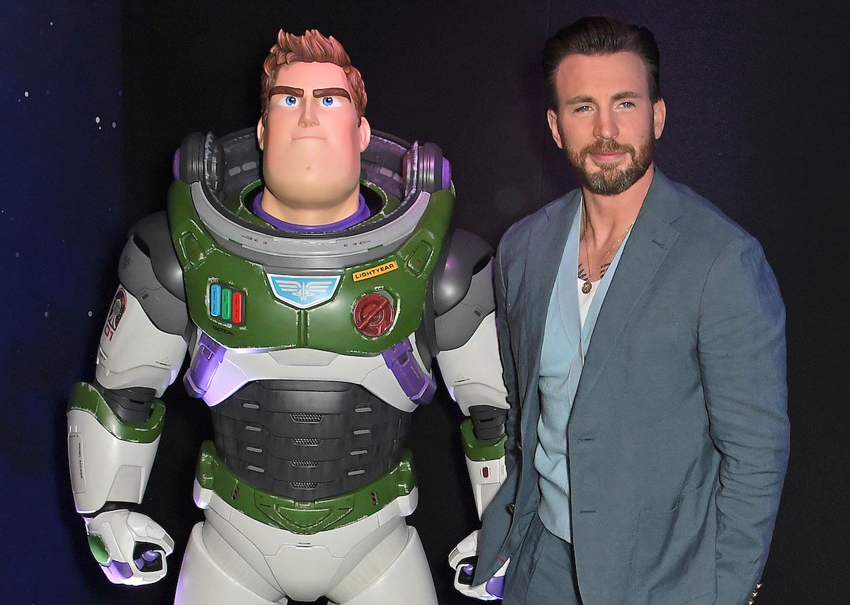 Chris Evans (right) poses next to a life-size Buzz Lightyear from the 2022 Pixar movie 'Lightyear.'