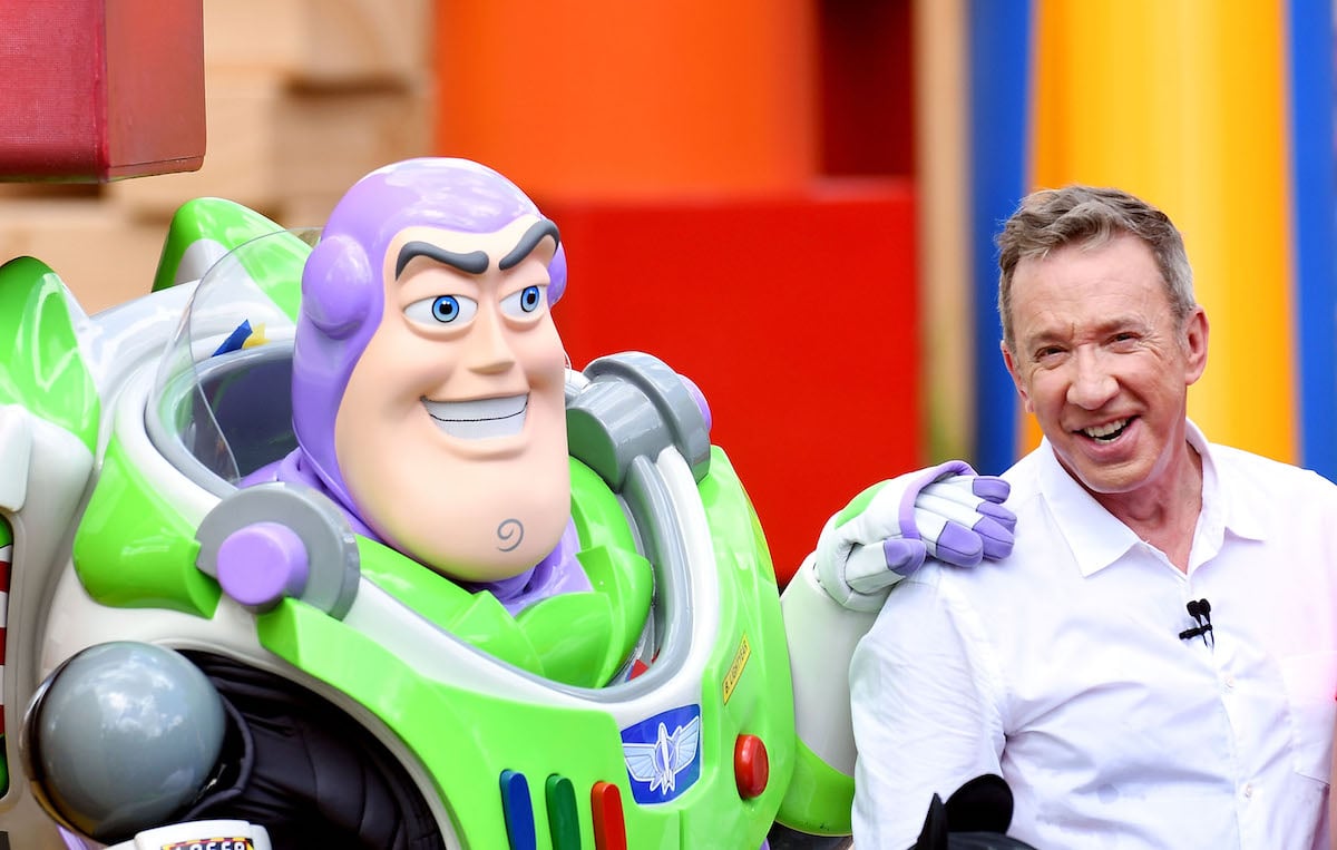 A person playing Buzz Lightyear and Tim Allen posing together in 2018
