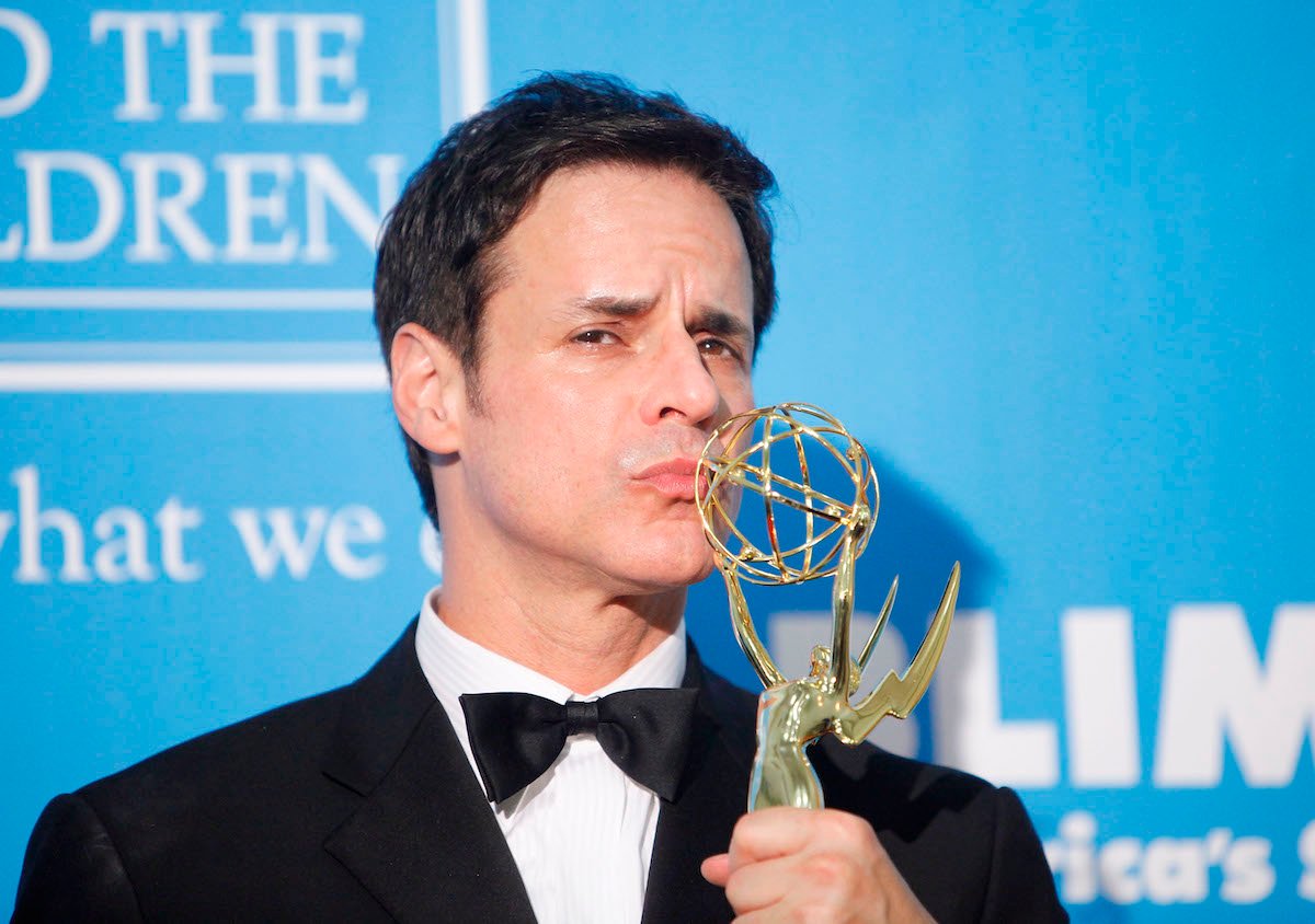 Daytime Emmys Outstanding Lead Actor in a Drama Series winner Christian LeBlanc poses kissing his trophy.