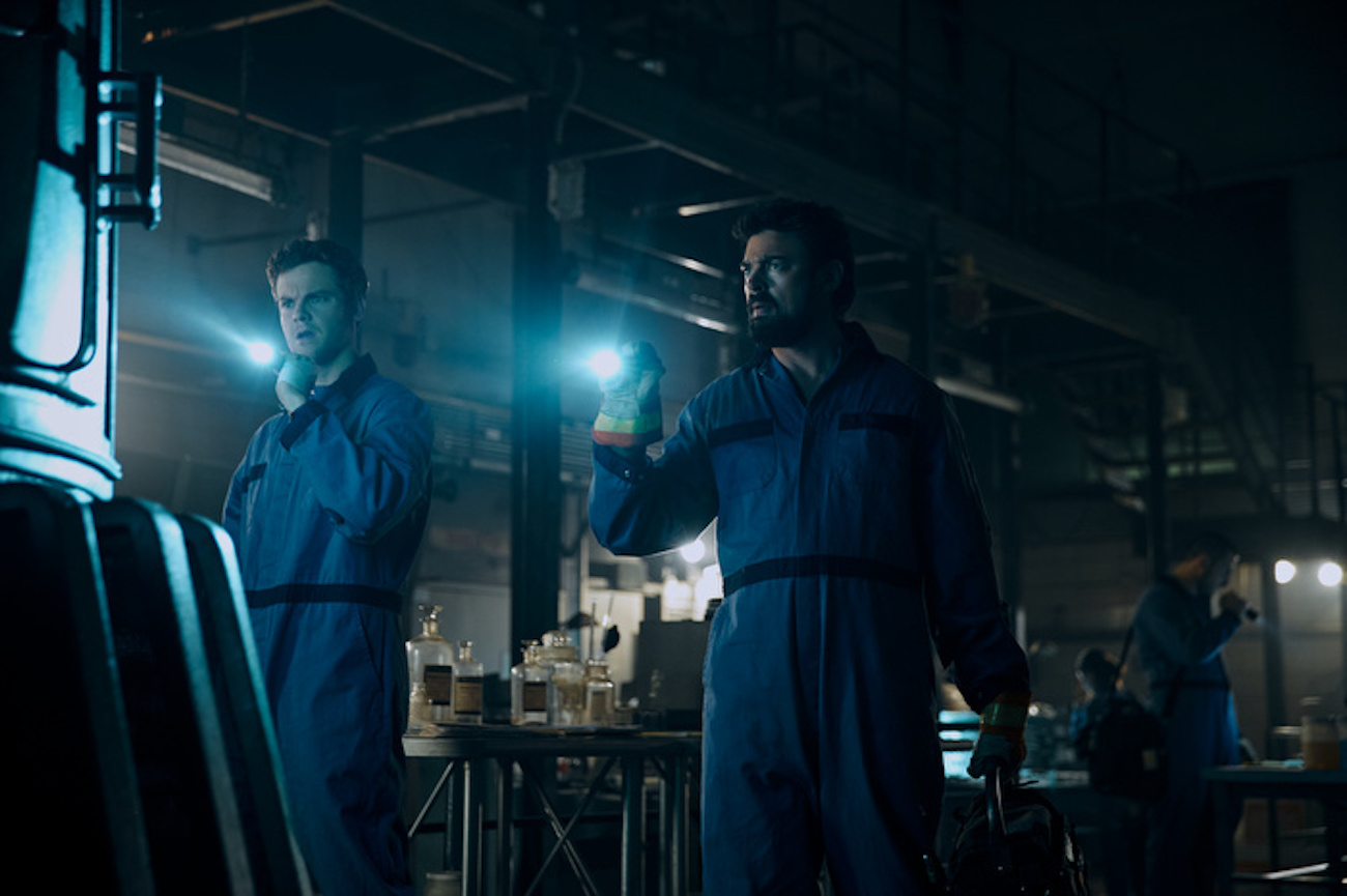 Hughie (Jack Quaid) and Butcher (Karl Urban) examine the container holding Soldier Boy in 'The Boys' Season 3