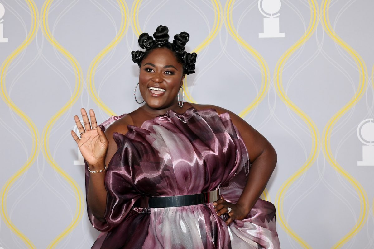 Danielle Brooks smiles while waving at the cameras at the 2022 Tony Awards