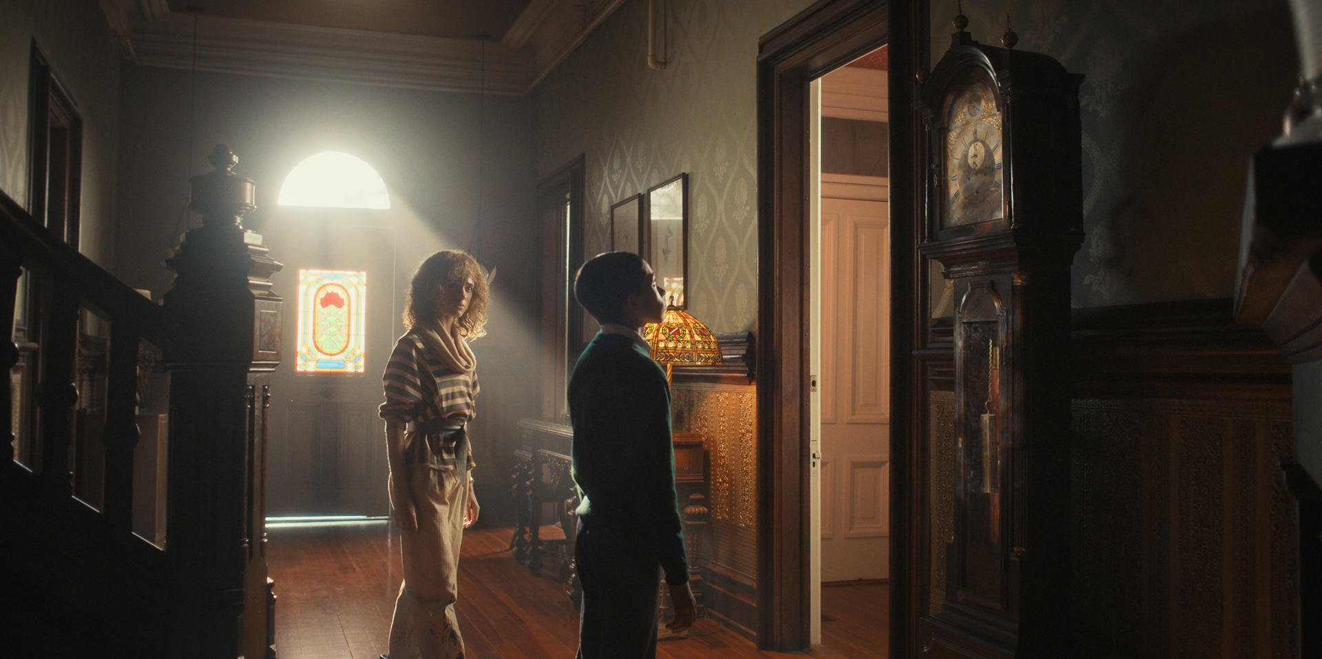 Nancy (Natalia Dyer) watches Henry Creel (Raphael Luce) stares at a grandfather clock in 'Stranger Things' 4 Vol. I