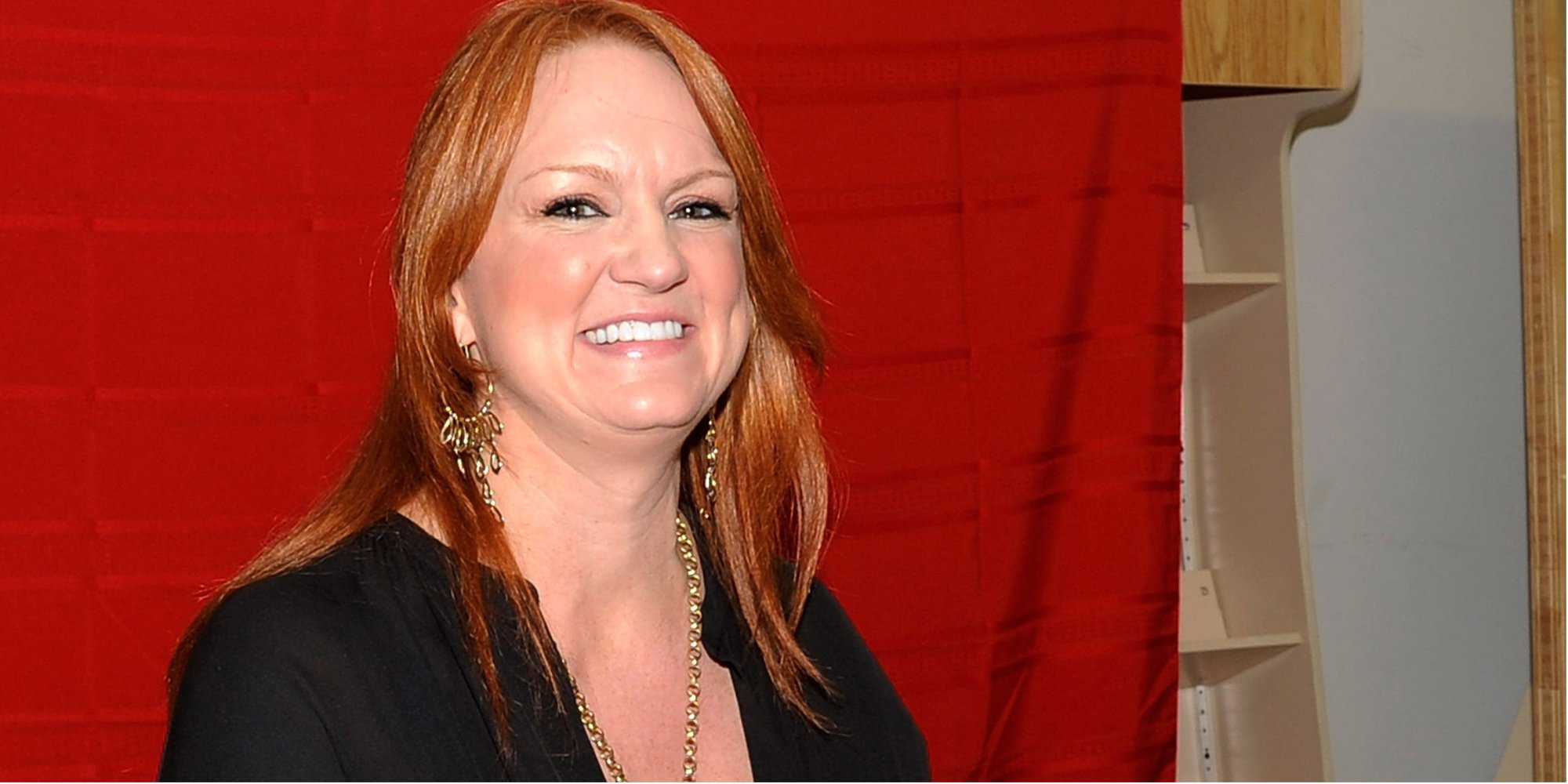 'The Pioneer Woman' star Ree Drummond poses in front of a red background wearing a black shirt and cooks for her kids.