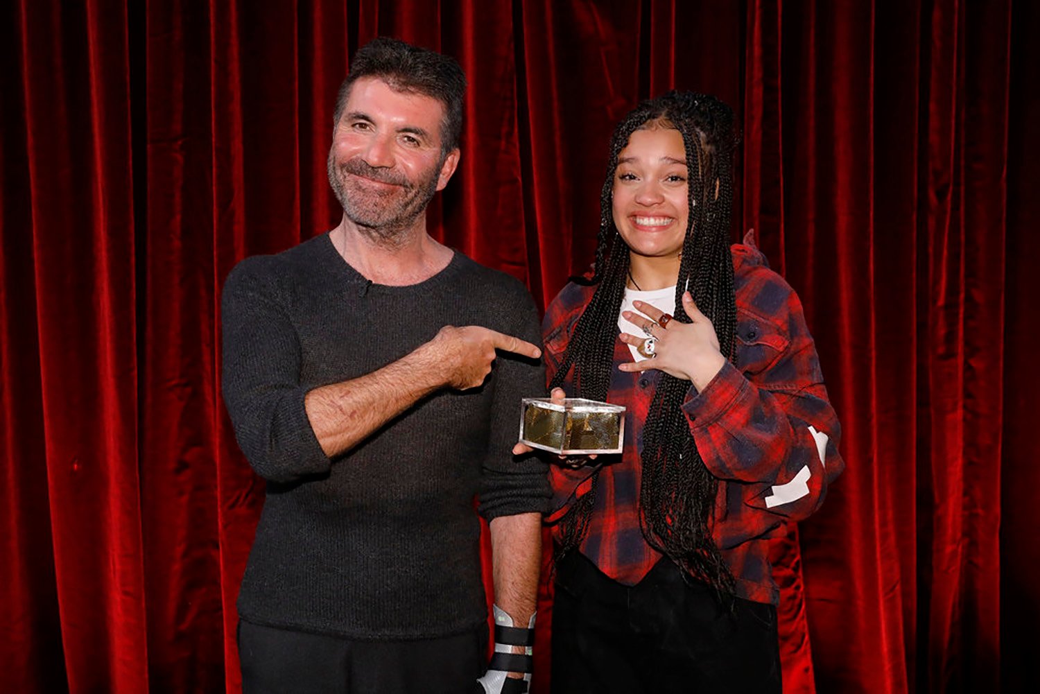 Simon Cowell poses with Golden Buzzer winner Sara James on Americas Got Talent