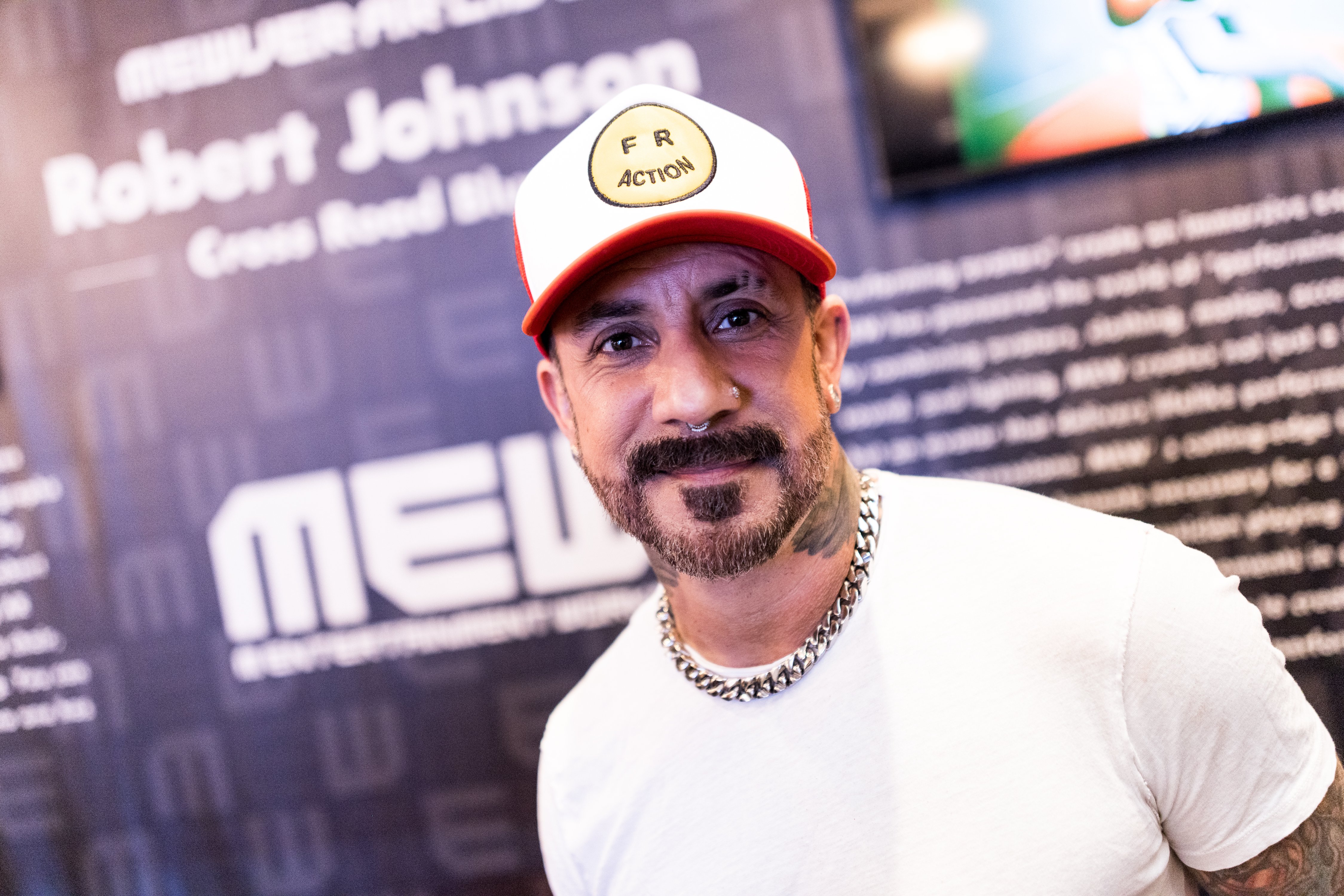 Backstreet Boys member AJ McLean in a white shirt and hat