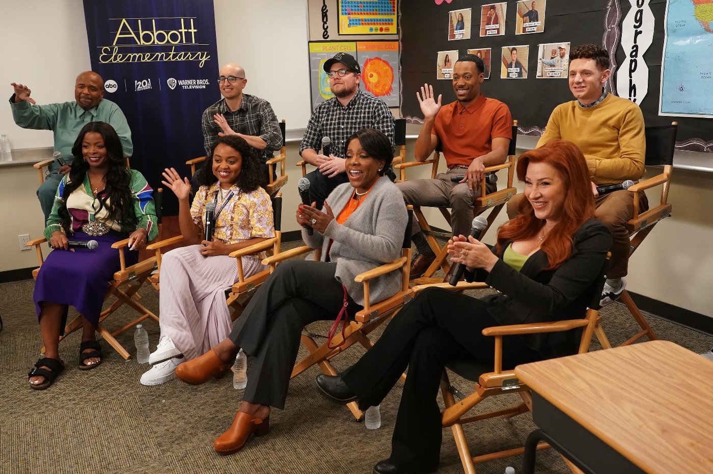 The cast of Abbott Elementary WILLIAM STANFORD DAVIS, JUSTIN HALPERN, PATRICK SCHUMACKER (EXECUTIVE PRODUCER), TYLER JAMES WILLIAMS, CHRIS PERFETTI, JANELLE JAMES, QUINTA BRUNSON (CREATOR AND EXECUTIVE PRODUCER), SHERYL LEE RALPH, LISA ANN WALTER sit together at Comic-Con 2022.