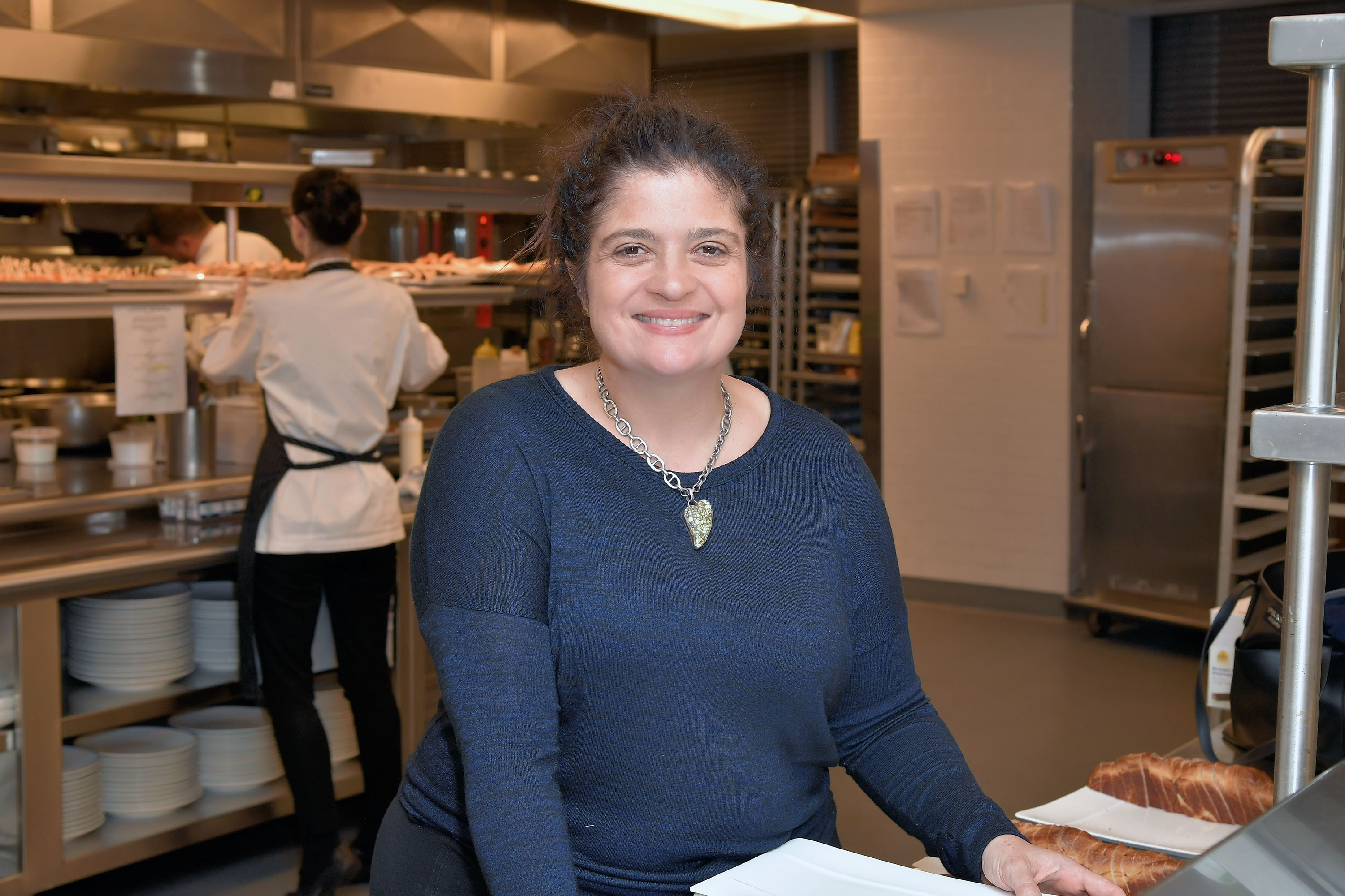 Celebrity chef Alex Guarnaschelli wears a long-sleeved blue blouse in this photograph.