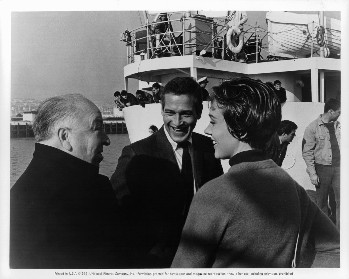 Alfred Hitchcock, Paul Newman, and Julie Andrews chat on the set of the 1966 film 'Torn Curtain'