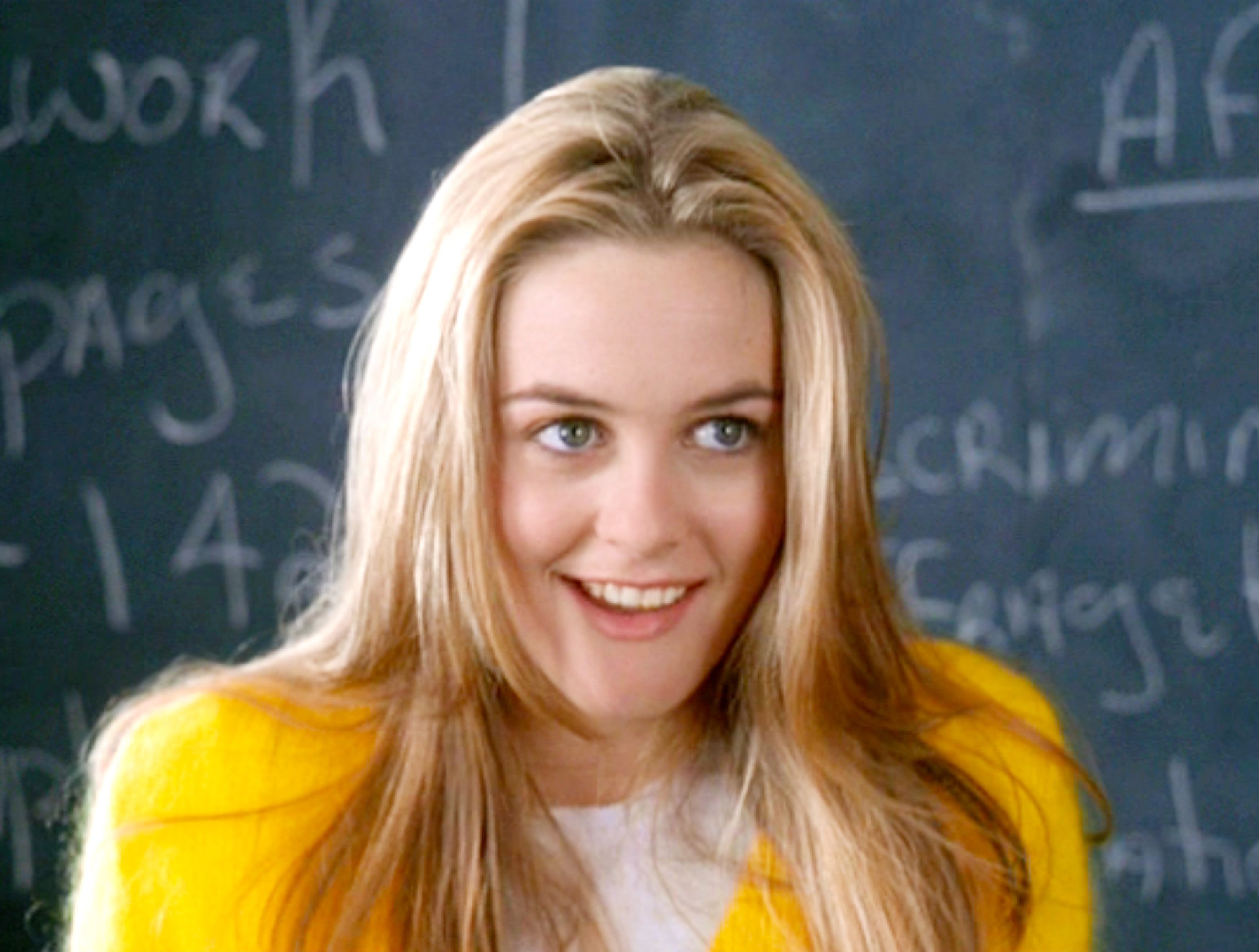 Alicia Silverstone as Cher, in front of a chalkboard, in 'Clueless'