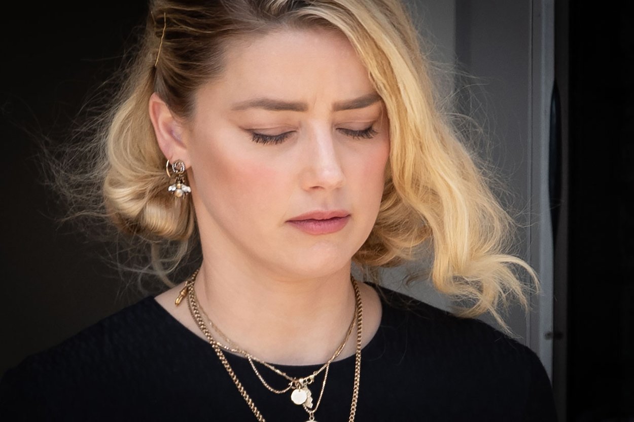 Amber Heard leaves the courthouse in Fairfax, Virginia, on June 1, 2022, after the jury delivered the verdict in her trial vs. Johnny Depp. Heard was sued by a former insurer over a $1 million policy as Depp seemed to slam her in a pair of new songs.