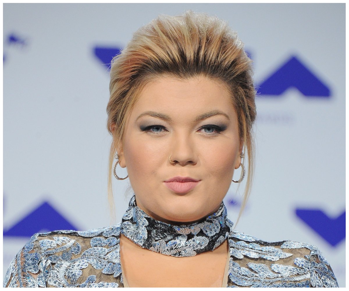 Amber Portwood, who just lost her custody battle for her son, smiles and poses at an event.