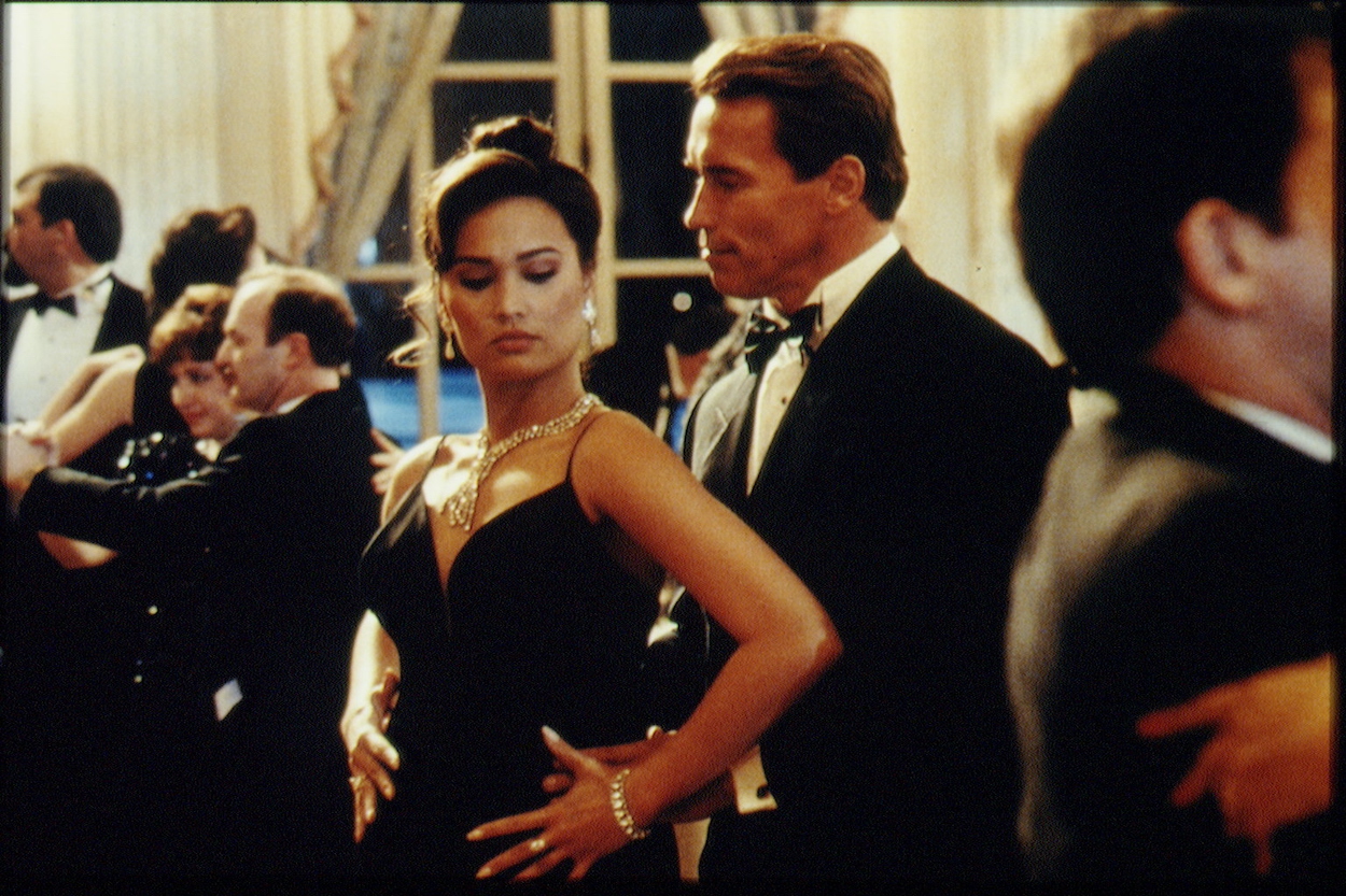 Tia Carrere (center left) and Arnold Schwarzenegger film 'True Lies.' Carrere recently revealed Schwarzenegger's dancing practice wasn't enough to avoid a nearly costly mistake while filming.
