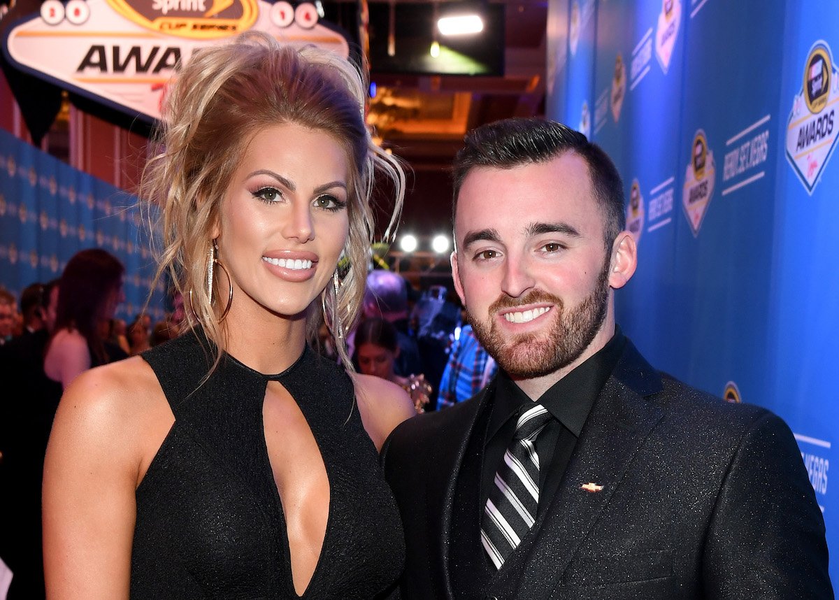 Austin Dillon and Whitney Dillon smile and pose together at an event.