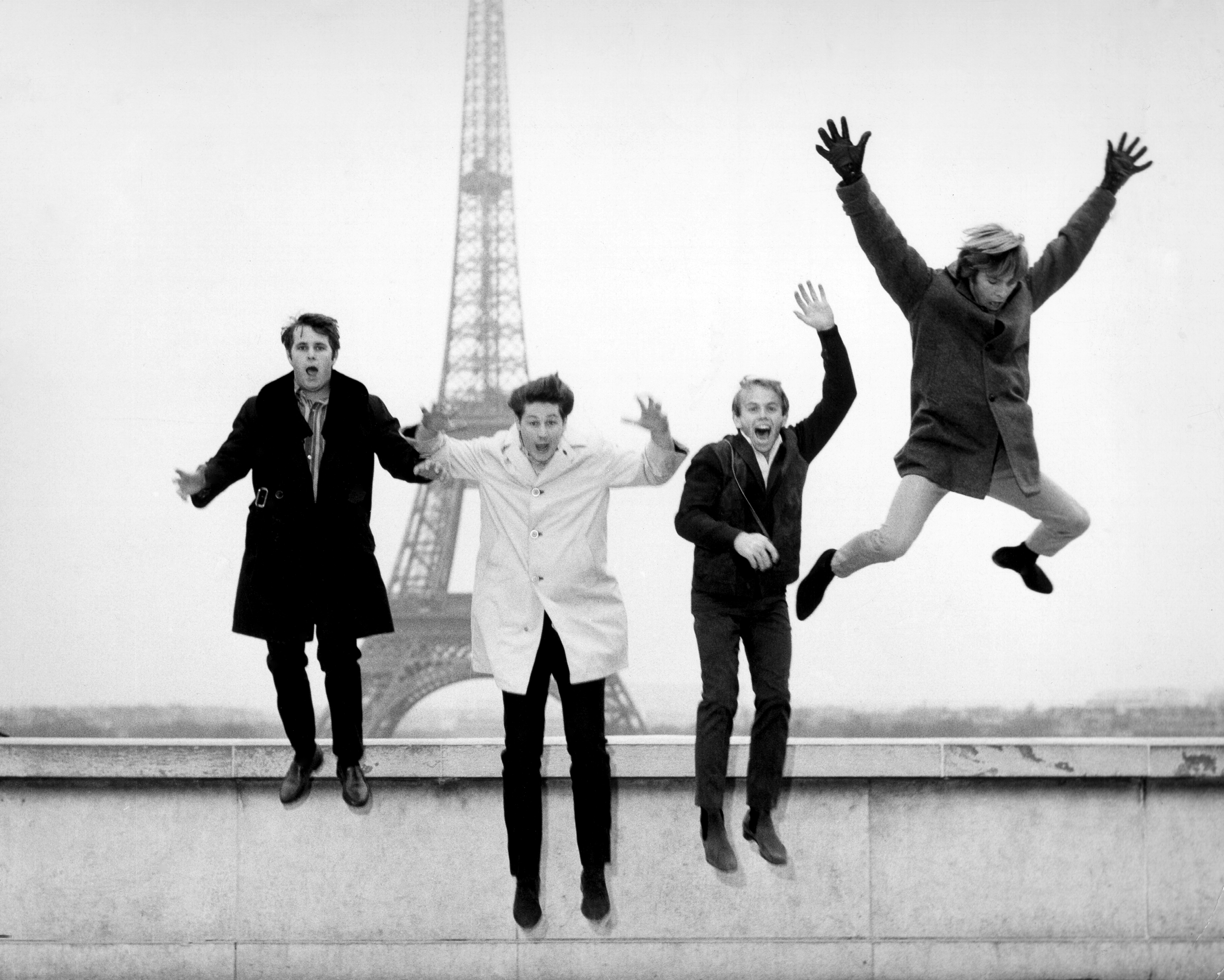 Rock band The Beach Boys jump off a ledge in front of the Eiffel Tower