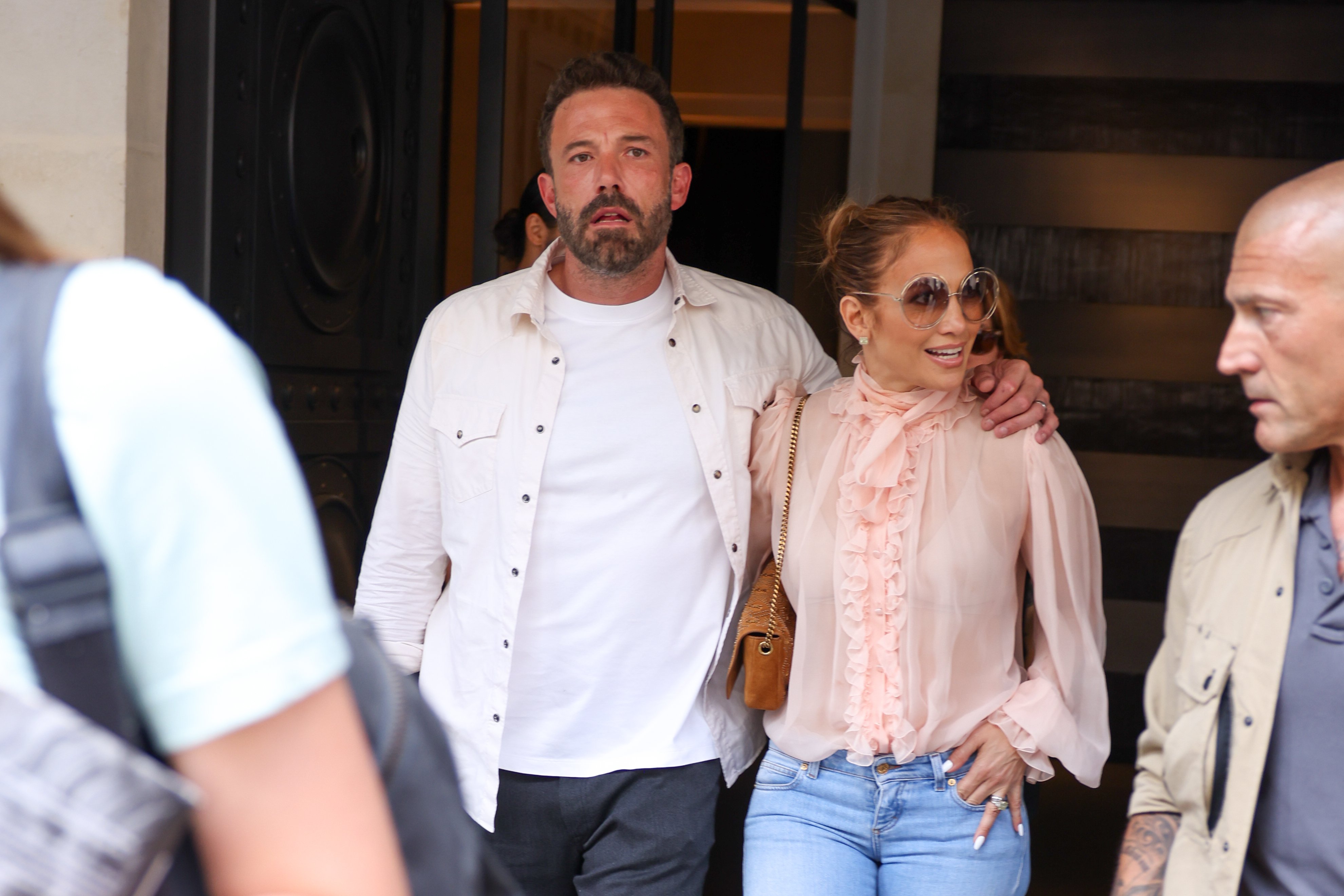 Ben Affleck and Jennifer Lopez walk side by side.