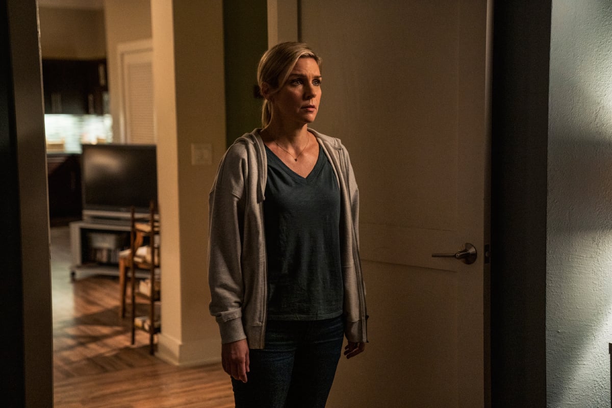 Rhea Seehorn as Kim Wexler in Better Call Saul Season 6 Episode 9. Kim stands in her apartment looking sad.  