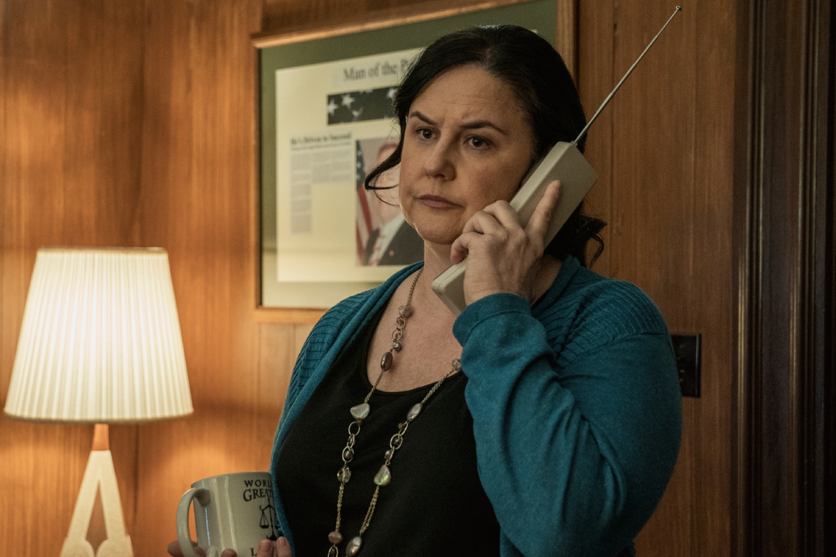 Tina Parker as Francesca Liddy in Better Call Saul Season 6 Episode 9. Francesca holds a phone to her ear, looking annoyed.