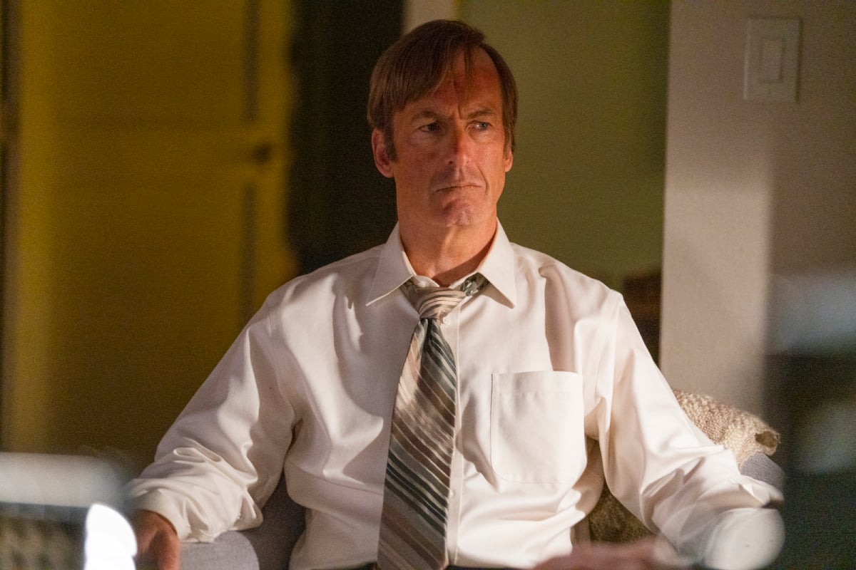 Jimmy McGill repeats a familiar line in Better Call Saul Season 6 trailer. Jimmy sits in a chair wearing a tie and white shirt. He has a sunburned face. 