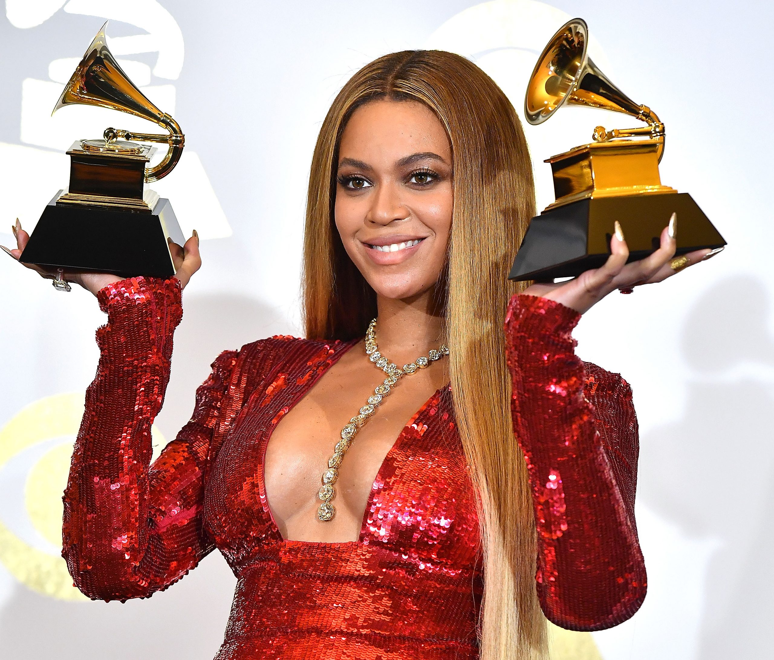 Beyoncé, wearing a red dress and holding Grammy Awards, has looked up to Michael Jackson for years