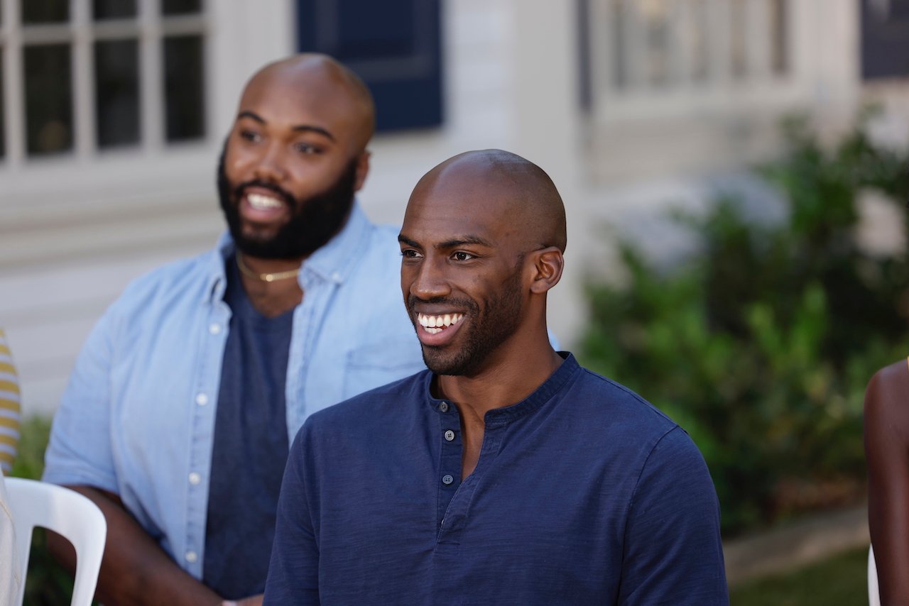 Finalists Derek Frazier and Xavier Prather sit on chairs outdoors for 'Big Brother 23' interview.