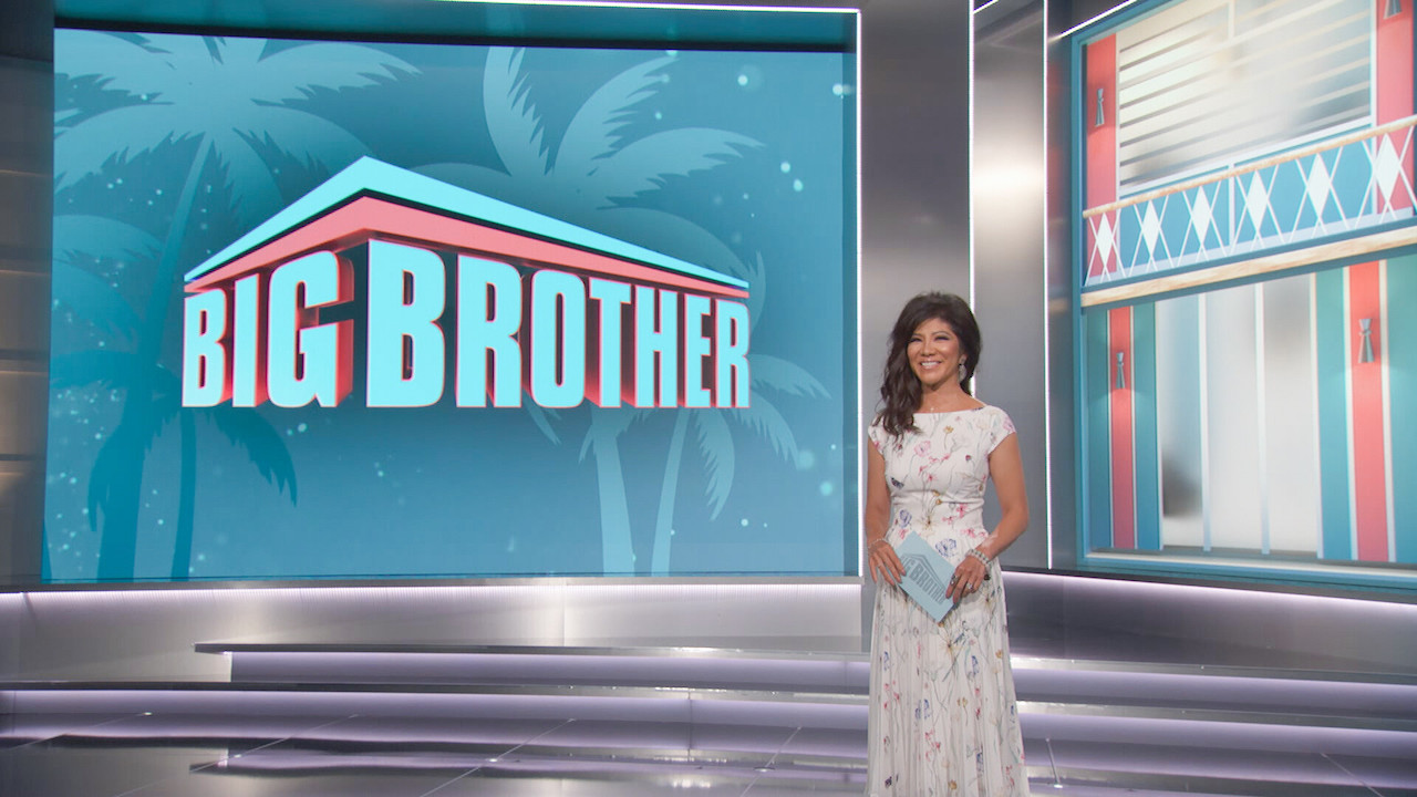 Julie Chen Moonves stands on stage in a white floral dress of 'Big Brother 24'.