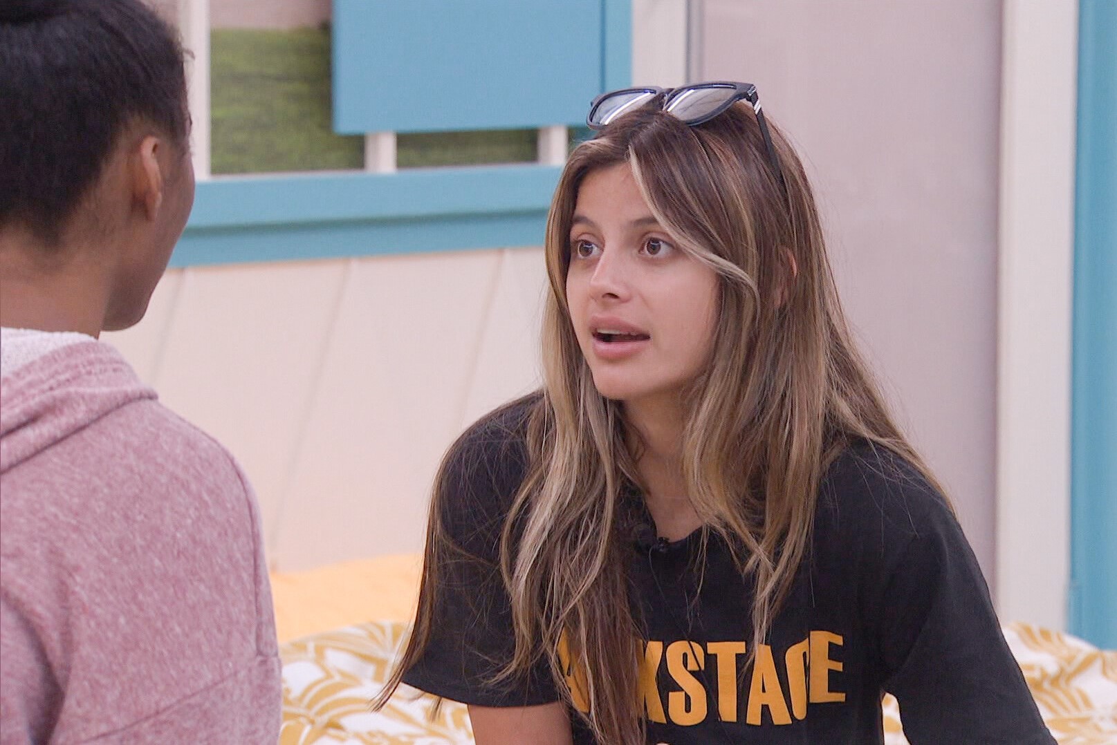 Taylor Hale and Paloma Aguilar discuss the game during an episode of 'Big Brother 24.' Taylor wears a light pink hoodie. Paloma wears her black Backstage shirt.