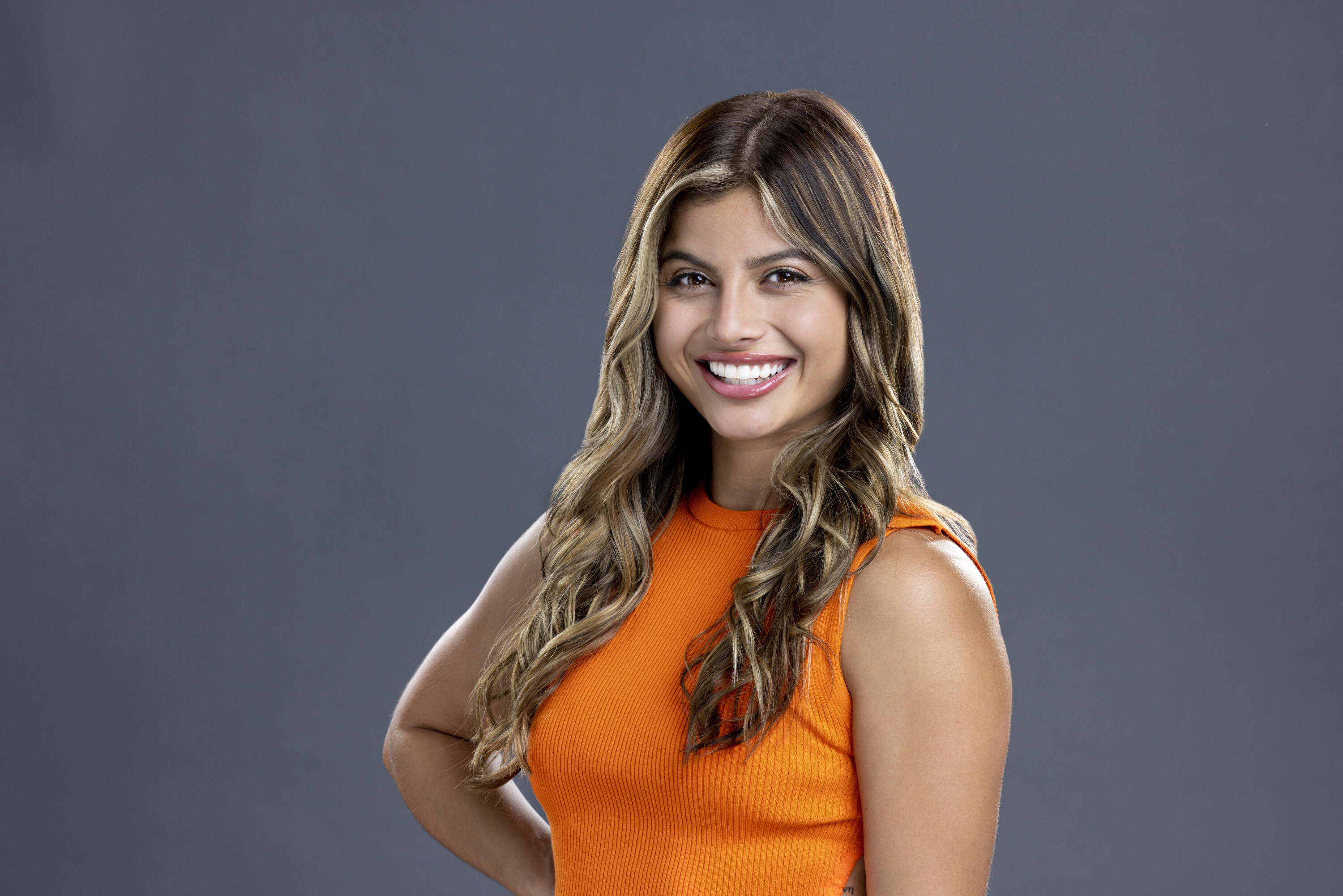 Paloma Aguilar, who competed in 'Big Brother 24,' wears an orange tank top.