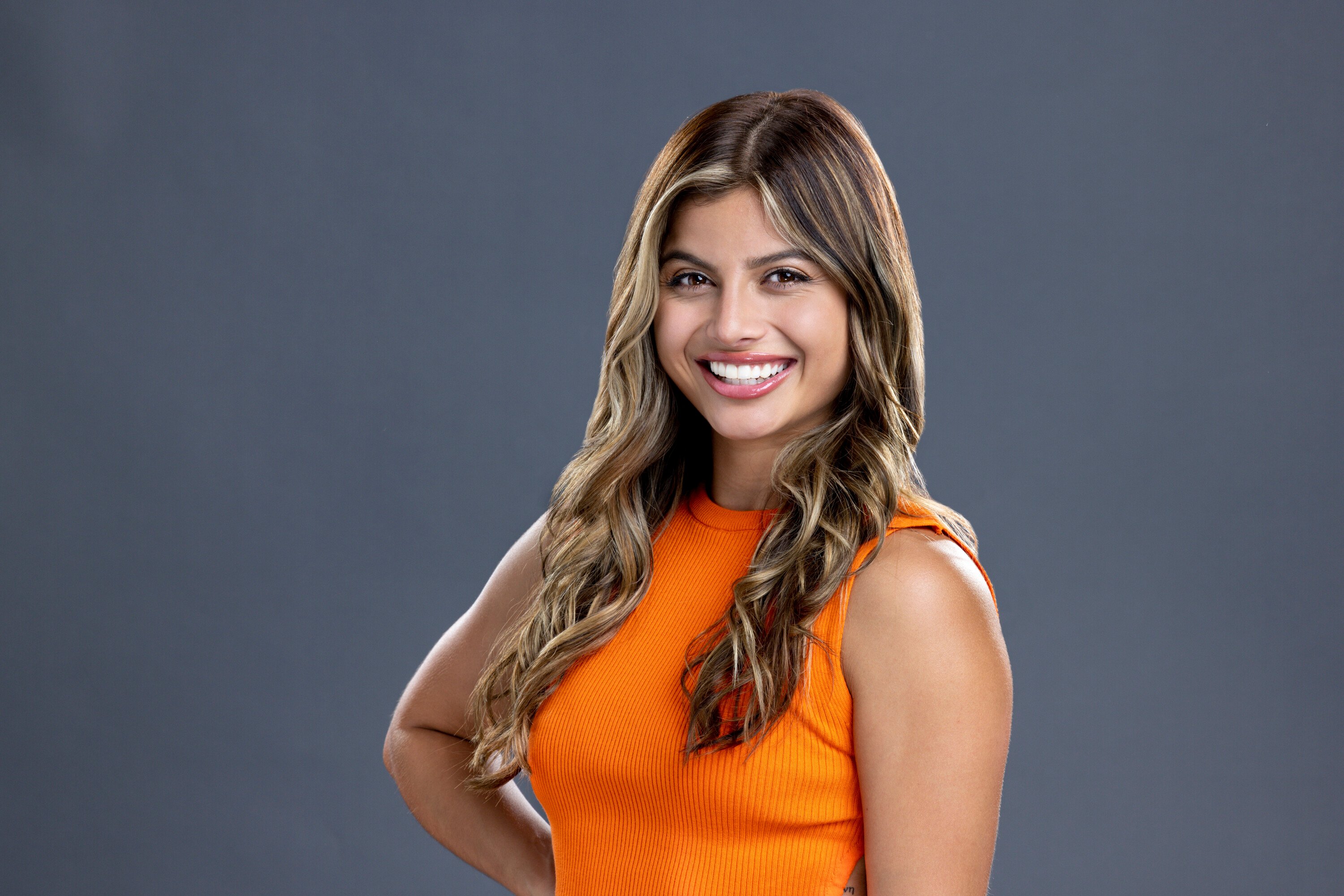 Paloma Aguilar, who competed in 'Big Brother 24,' wears an orange tank top.