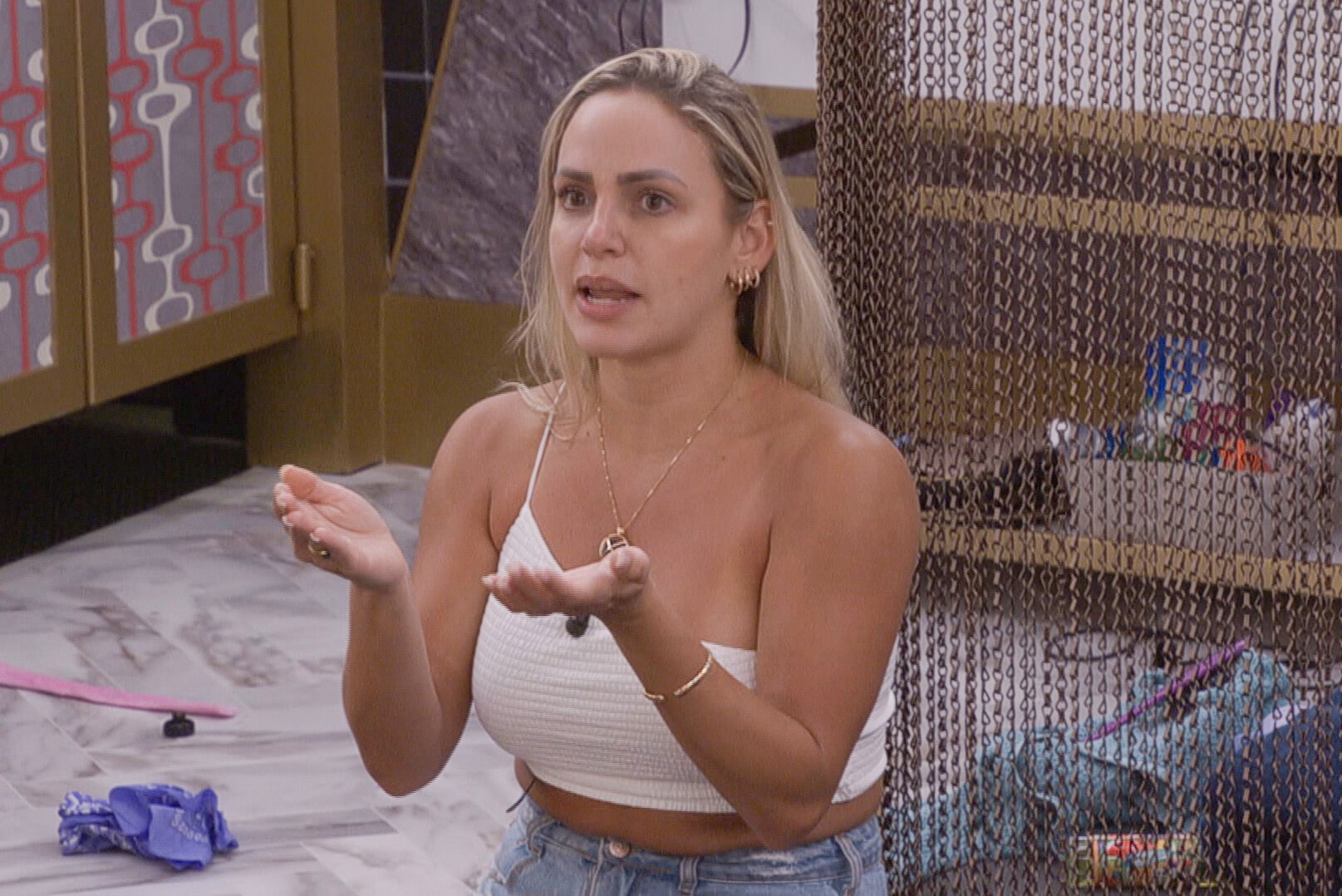 Indy Santos wears a cropped white tank top and jeans. Indy, according 'Big Brother 24' spoilers, wasn't happy with Brittany on Thursday, July 28.