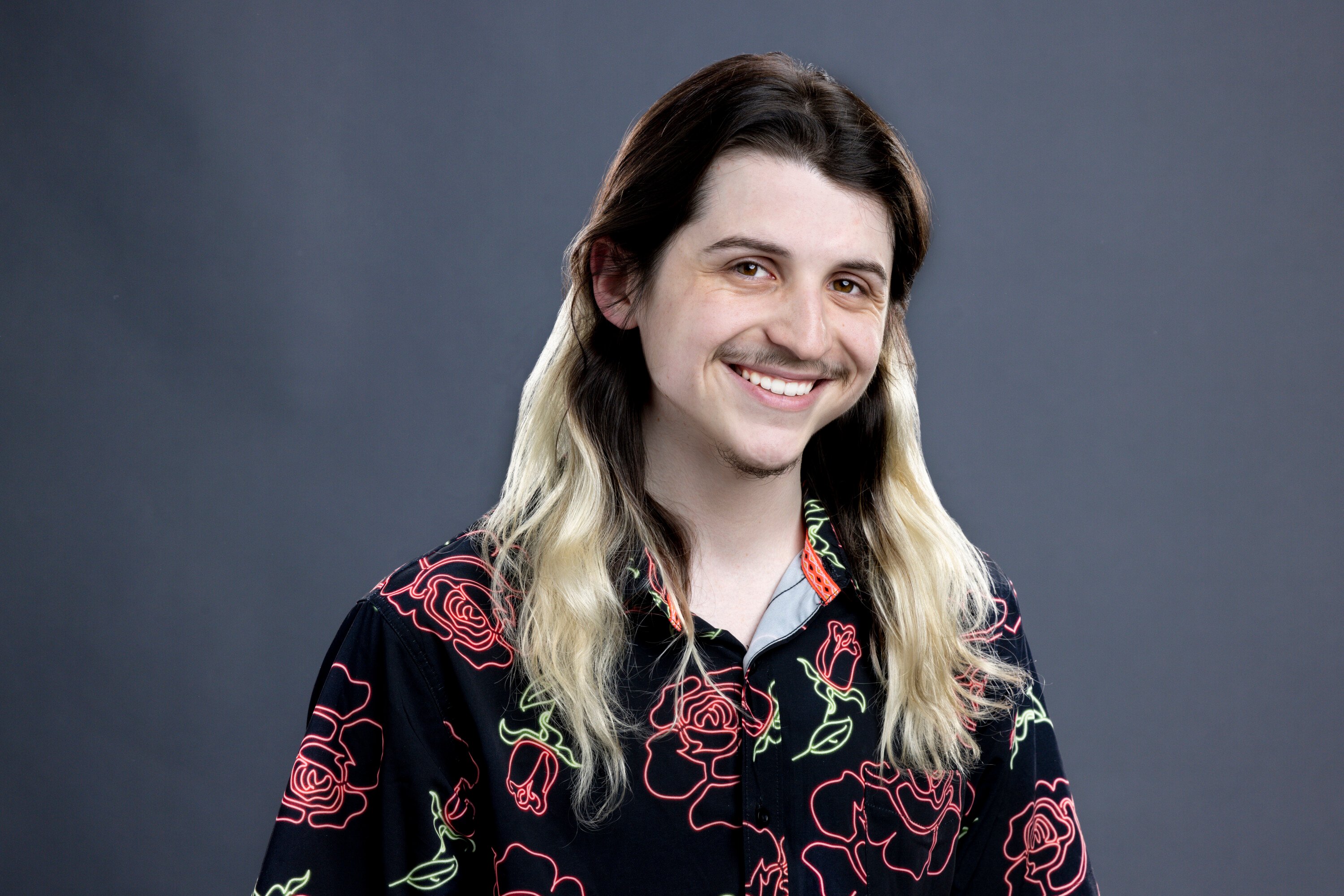 Matthew Turner, who is a part of the 'Big Brother 24' cast, wears a black button-up shirt with red roses on it.