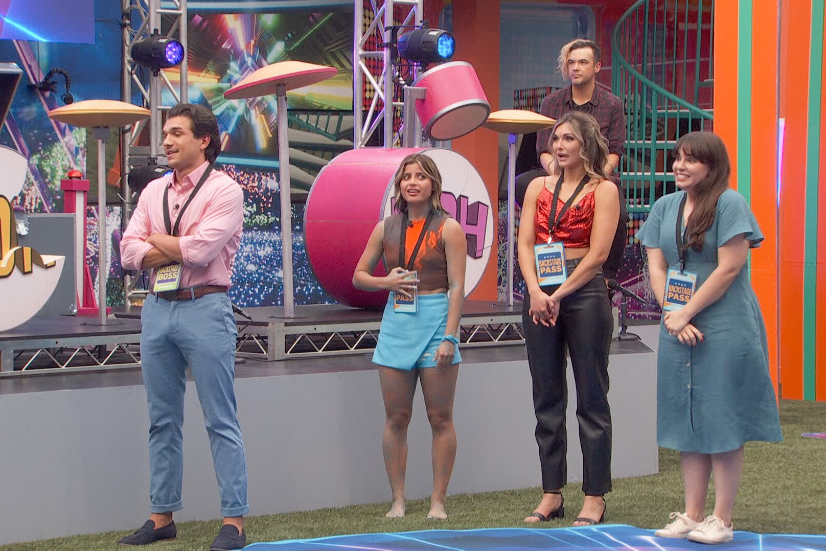 Joe 'Pooch' Pucciarelli, Paloma Aguilar, Alyssa Snider, and Brittany Hoopes, who are on 'Big Brother' Season 24, begin the game with, spoiler alert, backstage passes. They stand in a line in the backyard, which is set up for a competition.