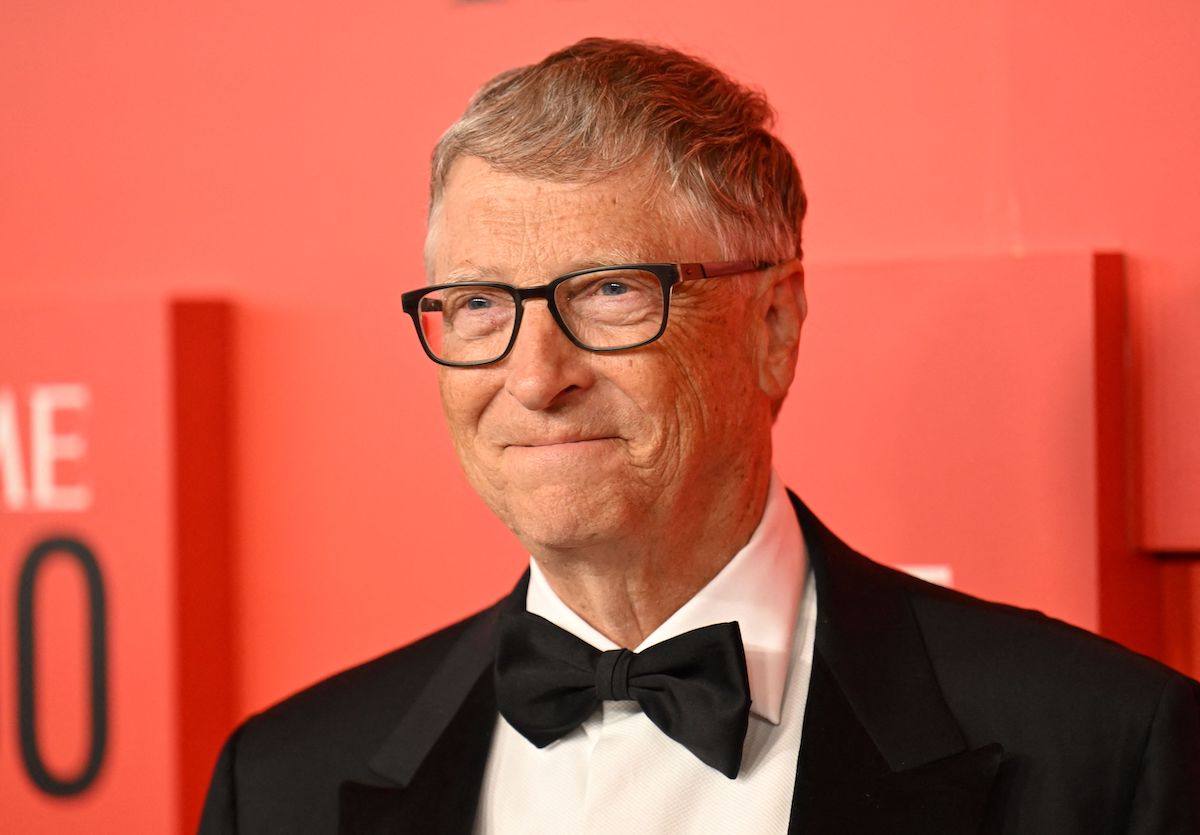 Bill Gates, who owns a collection of private jets, smiles and poses at an event.
