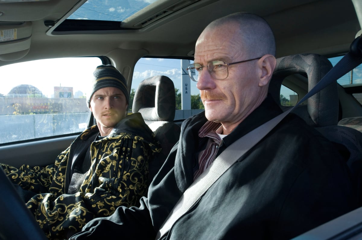 Aaron Paul and Bryan Cranston will appear as Walt and Jesse in Better Call Saul Season 6. Walt and Jesse sit in a car.