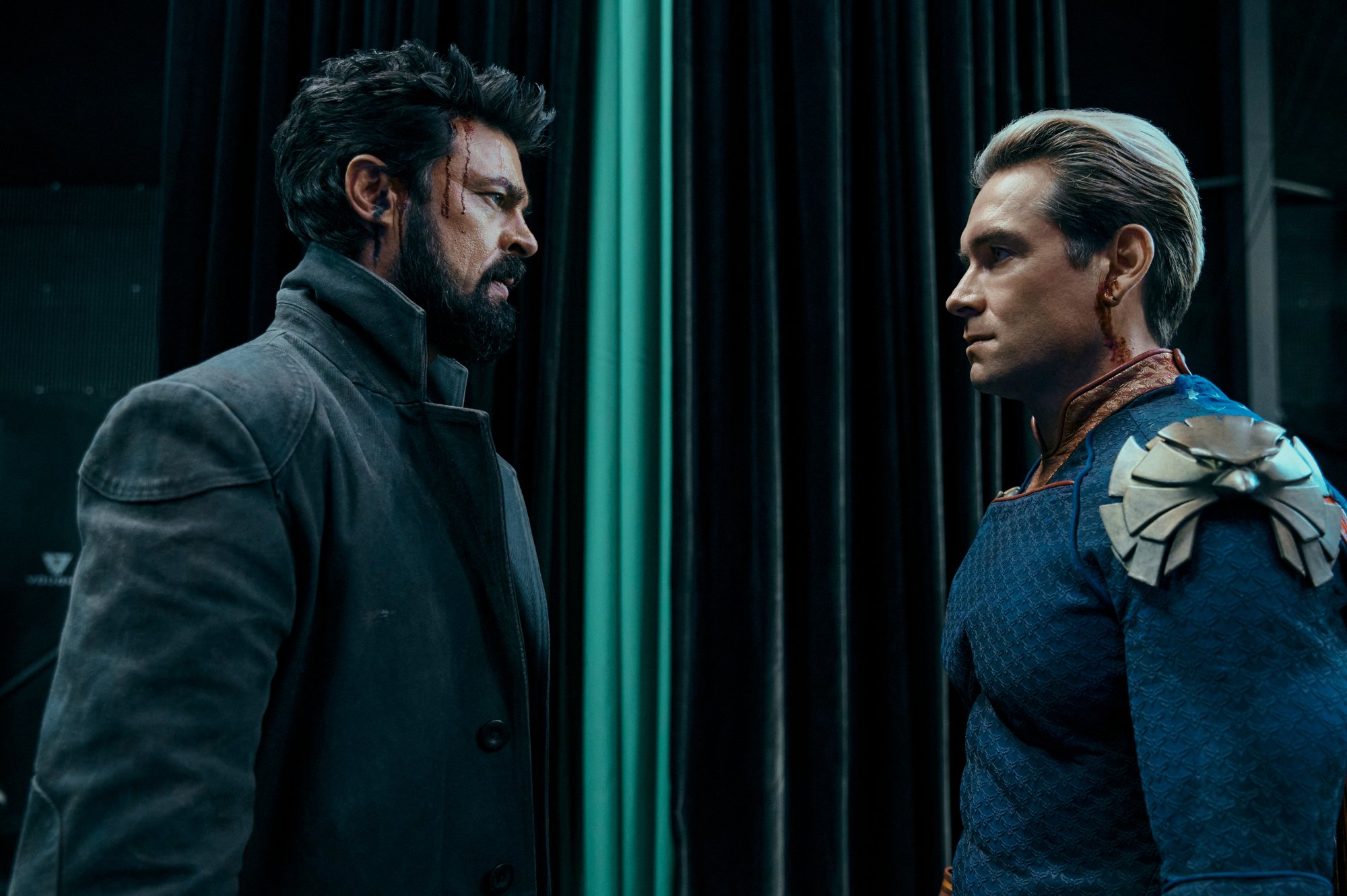 Karl Urban and Antony Starr as Billy Butcher and Homelander in 'The Boys' Season 3 finale, which has an ending that sets up season 4. The two are facing one another and wearing grim expressions.