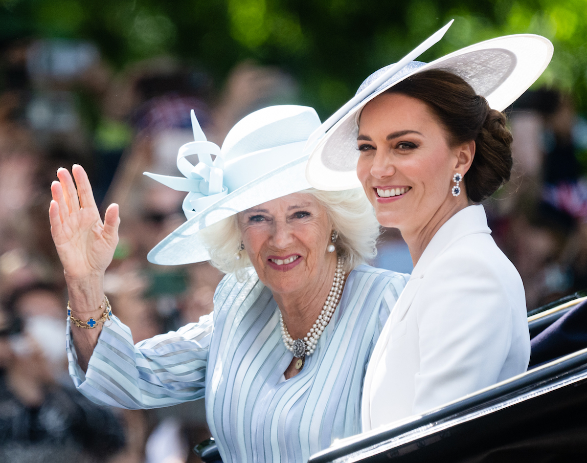 Camilla Parker Bowles, whom Kate Middleton photographed for Country Life magazine, sits with Kate Middleton in a carriage.