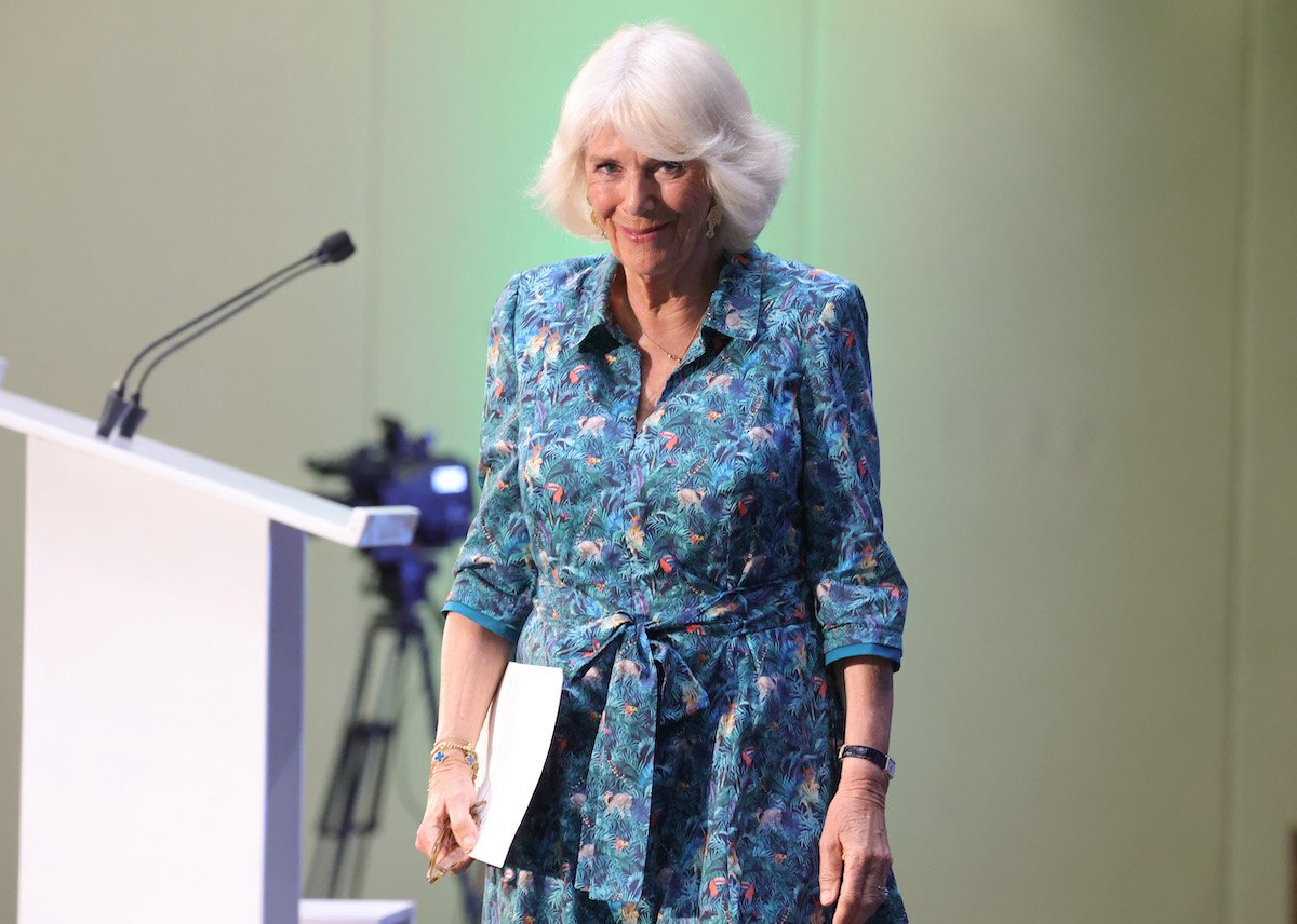 Camilla Parker Bowles, who doesn't like giving speeches, smiles as she stands near a lectern