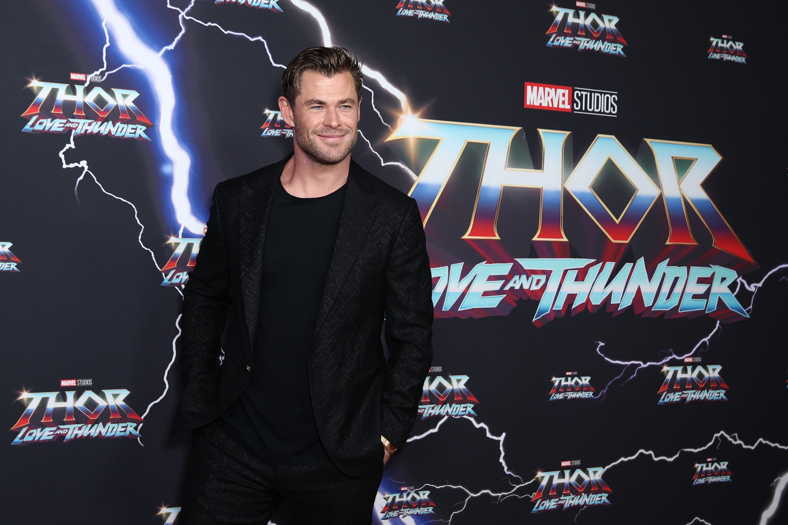 Chris Hemsworth, who owns a $30 million mansion, smiles on the carpet at the Sydney premiere of 'Thor Love and Thunder'