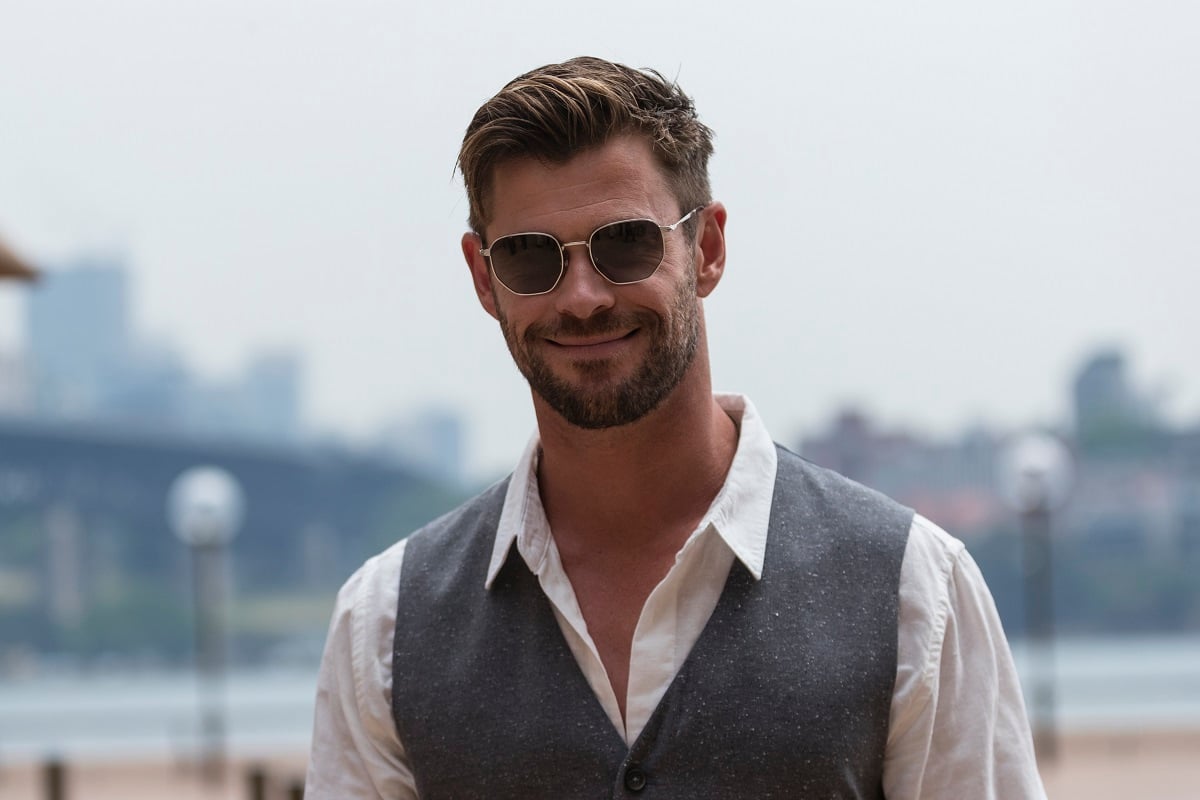 Chris Hemsworth posing while weariing a suit.
