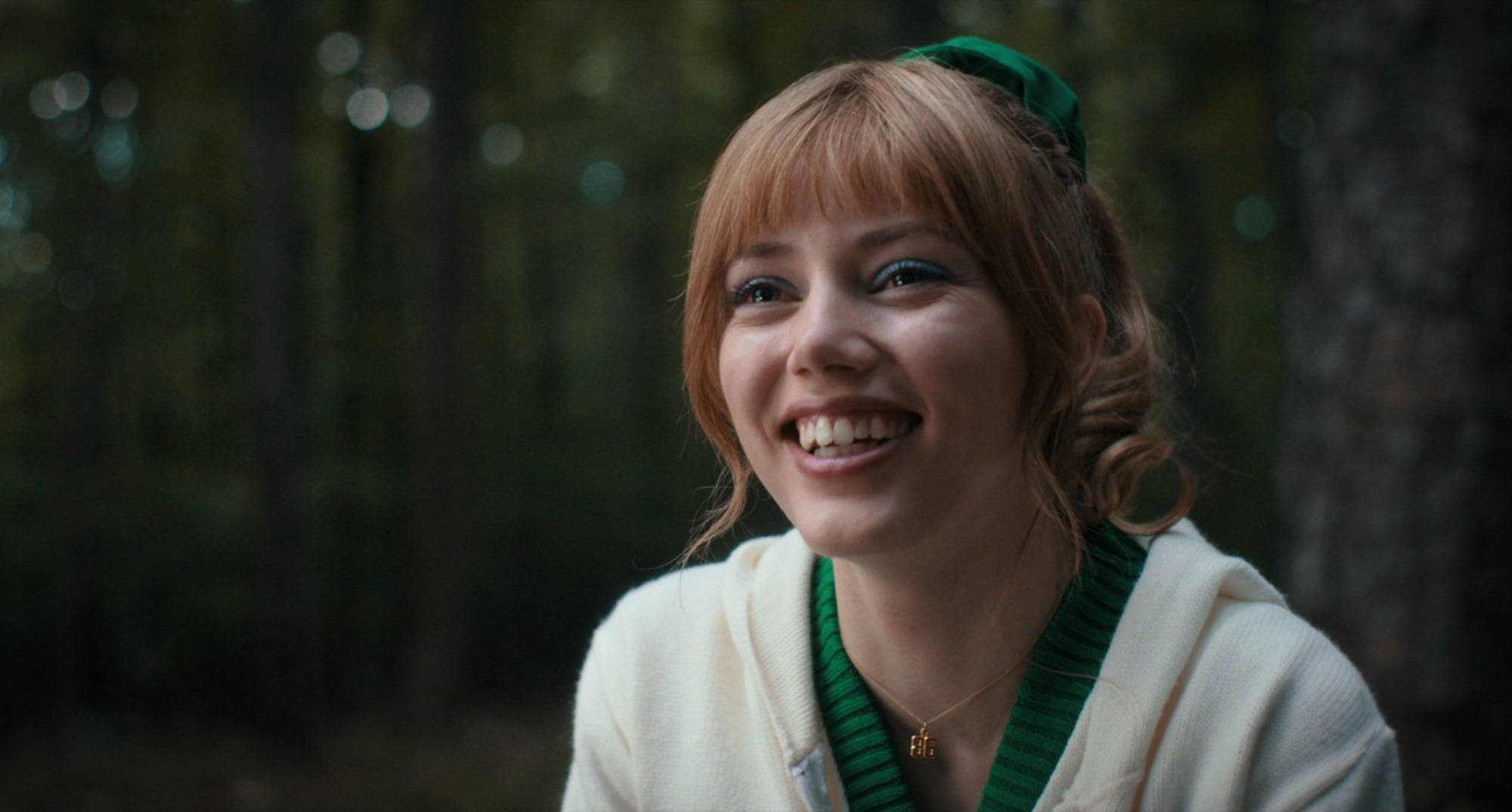 Chrissy Cunningham smiling at Eddie Munson in 'Stranger Things' Season 4 in the woods.