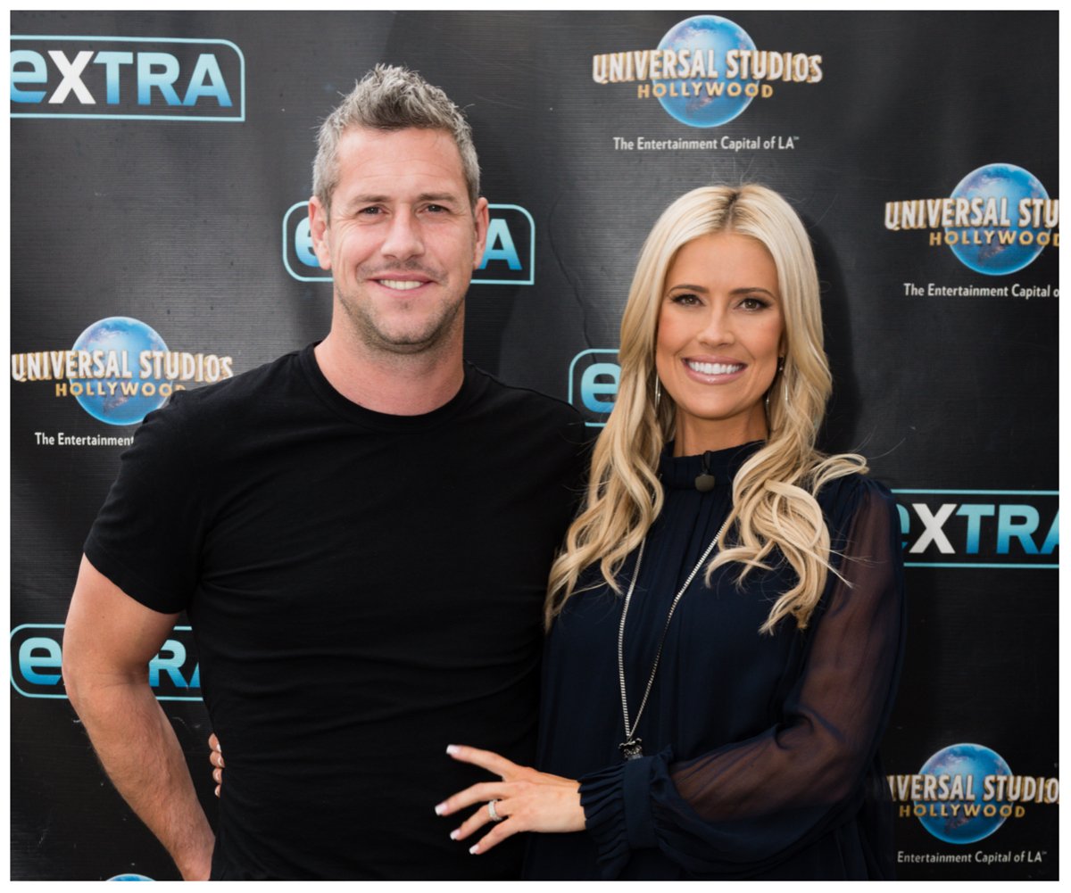 Ant Anstead and Christina Hall, who in a custody battle over their son Hudson, smile and pose together at an event.