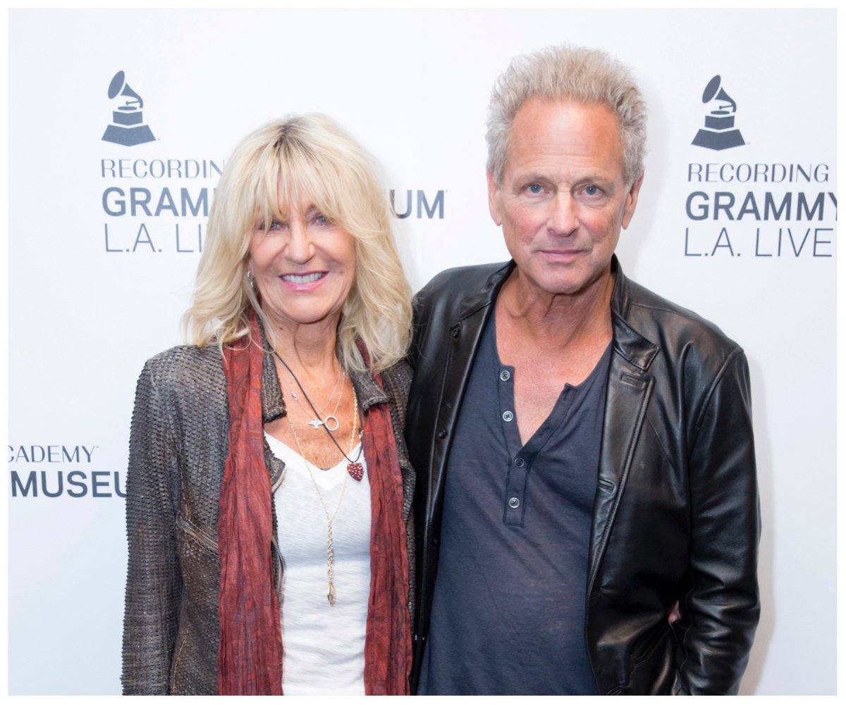 Christine McVie and Lindsey Buckingham of Fleetwood Mac smile and pose together at an event.