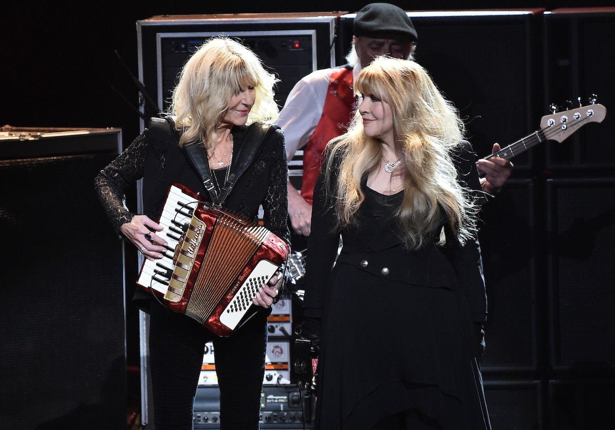 Christine McVie and Stevie Nicks perform on stage with Fleetwood Mac.