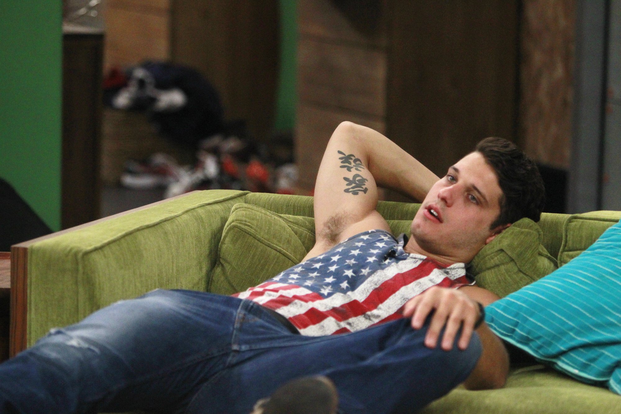 Cody Calafiore lying on a couch during 'Big Brother 16'